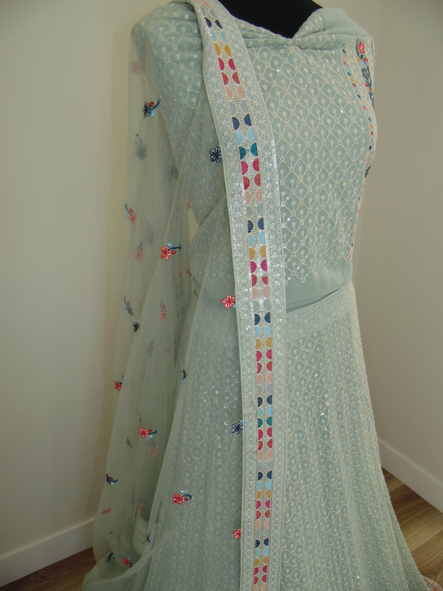 Light green Indian Lehenga with colorful heart pattern on a white background