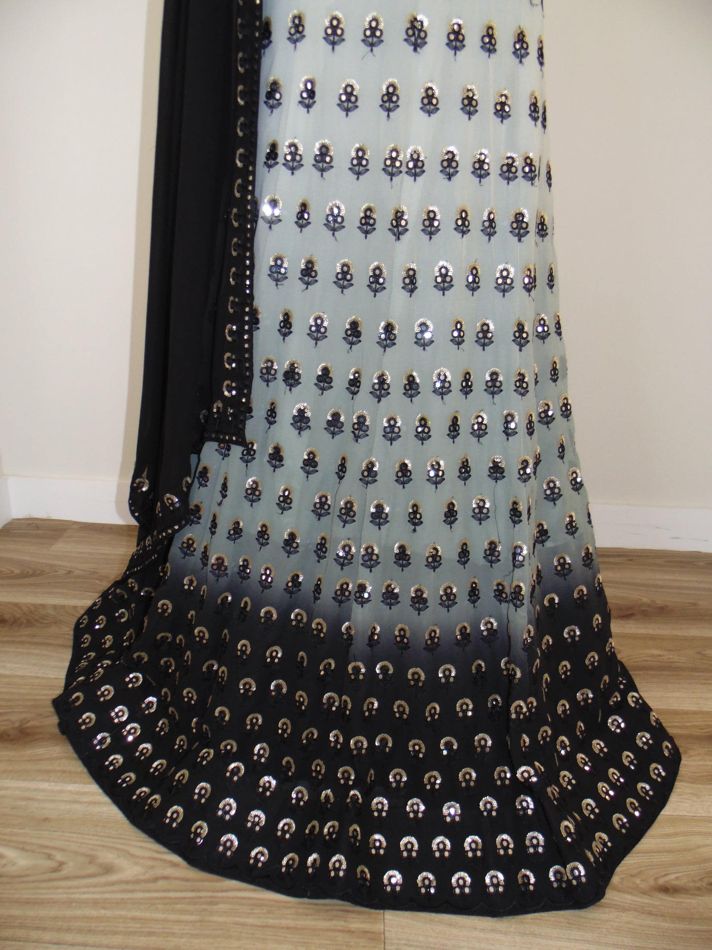 Black and gold patterned fabric on a wooden surface