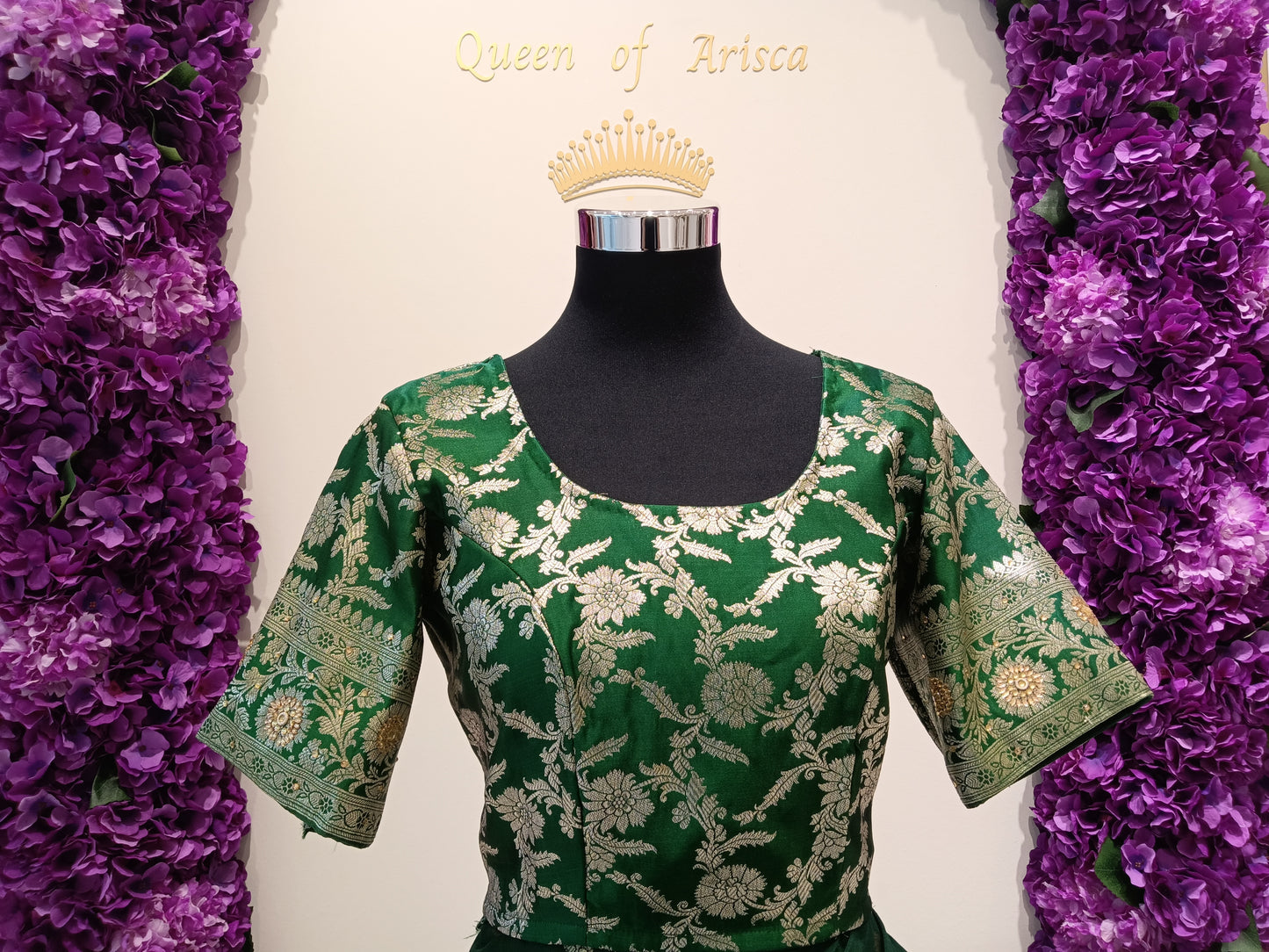 Blouse with gold zari floral embroidery and delicate stone .