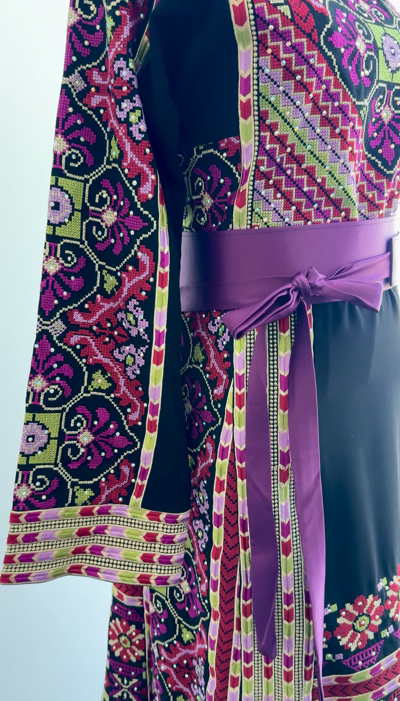Close-up of Tatreez embroidery on black fabric – traditional Palestinian dress