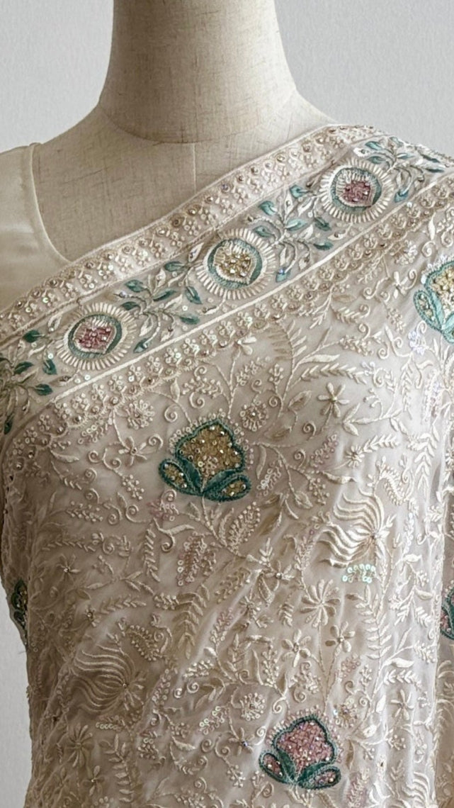 Close-up of white-on-white hand embroidery on georgette