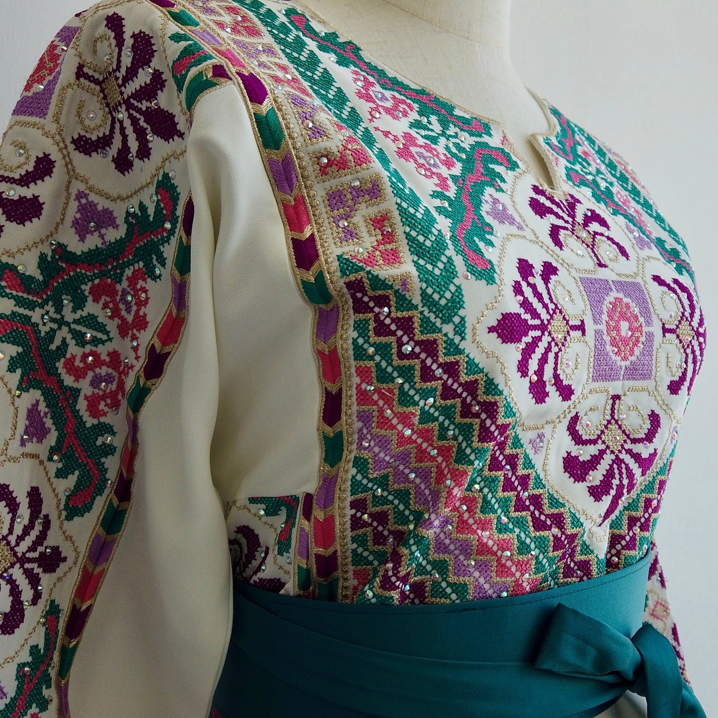 Close-up of embroidery patterns featuring vibrant motifs inspired by Palestinian cultural symbols
