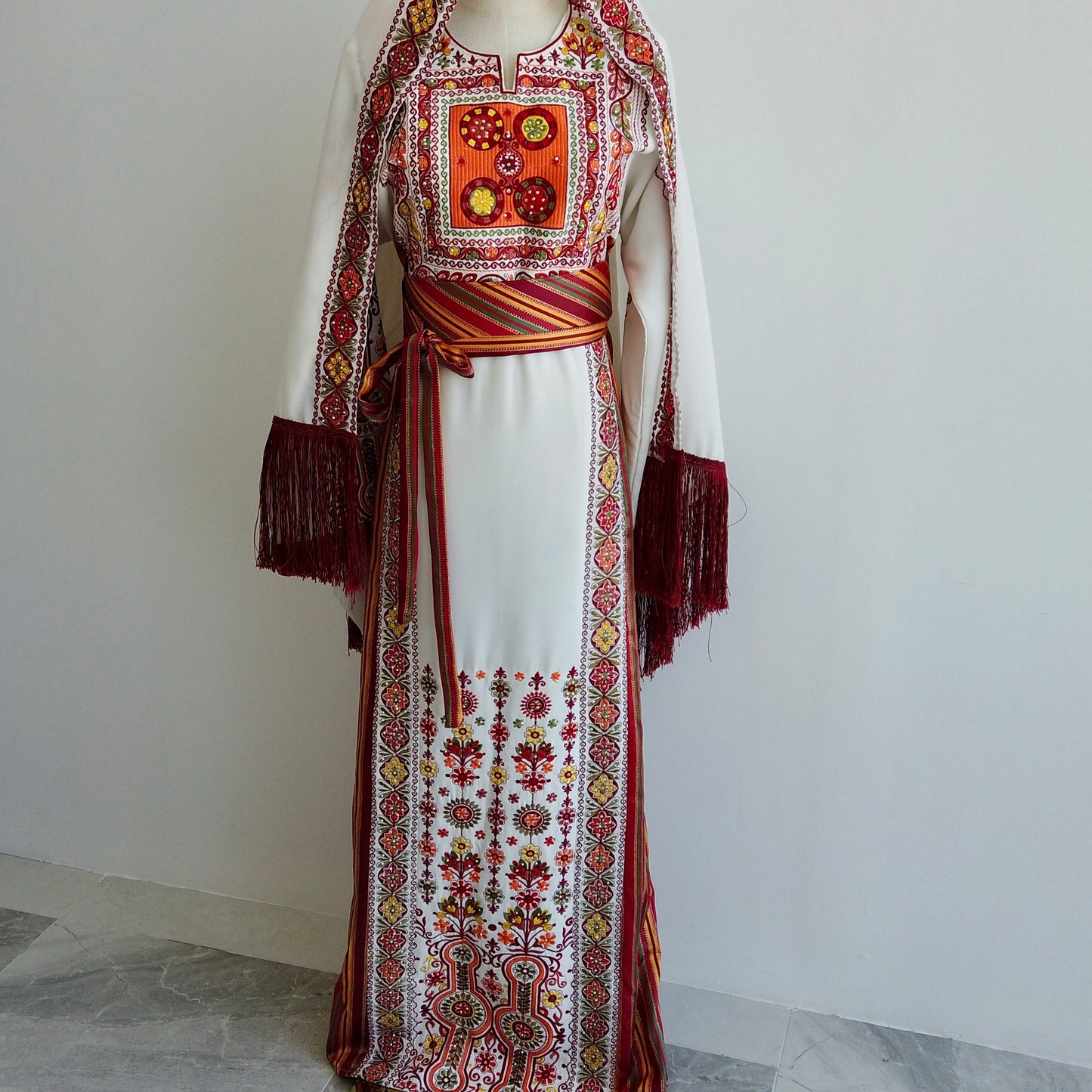 Front view of white Palestinian thobe with red and gold embroidery and matching shawl – Arisca Qatar