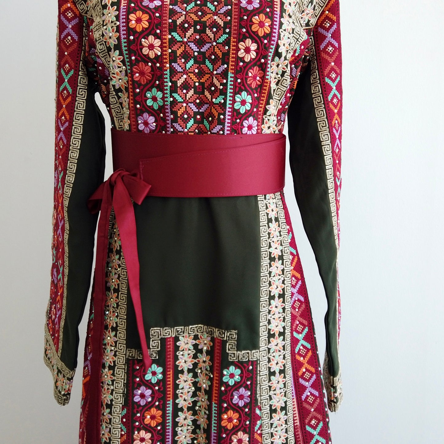 Close-up of colorful floral embroidery on Palestinian dress