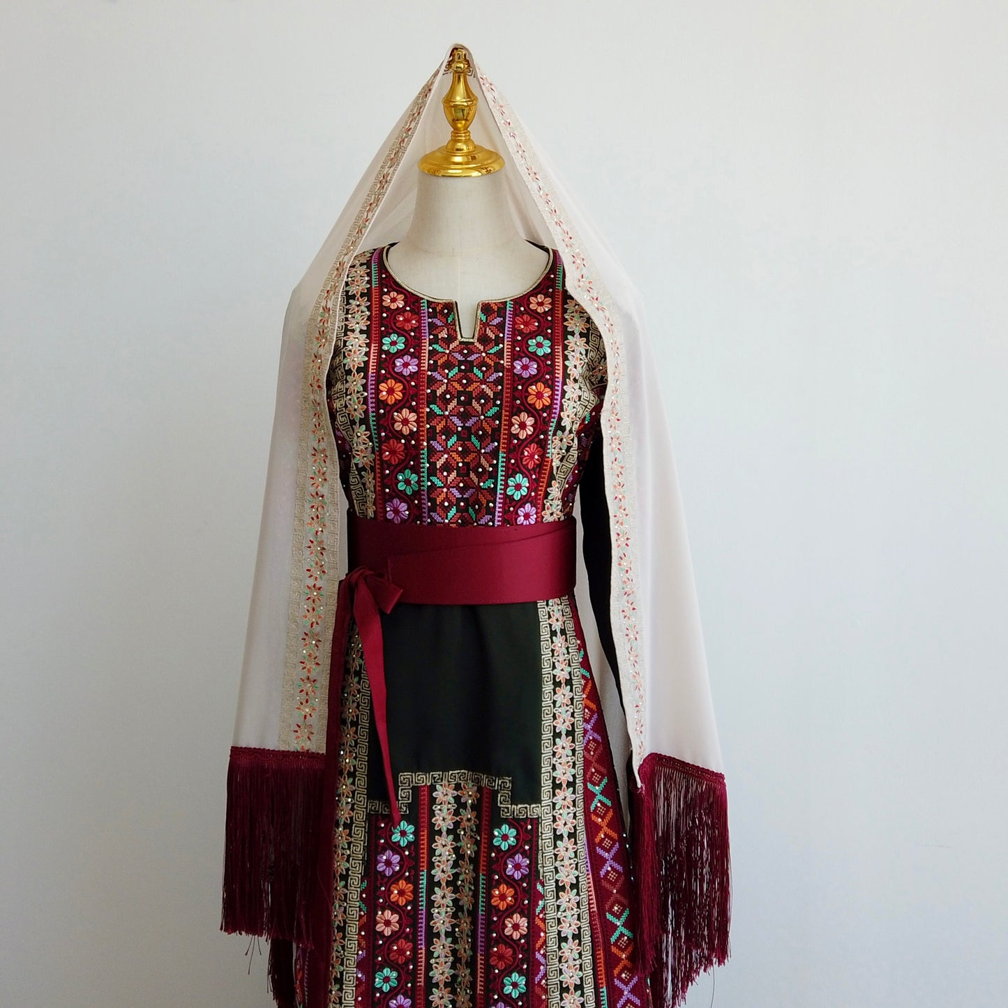 Traditional Palestinian thobe in deep red and green with cream shawl and satin belt – Arisca Qatar