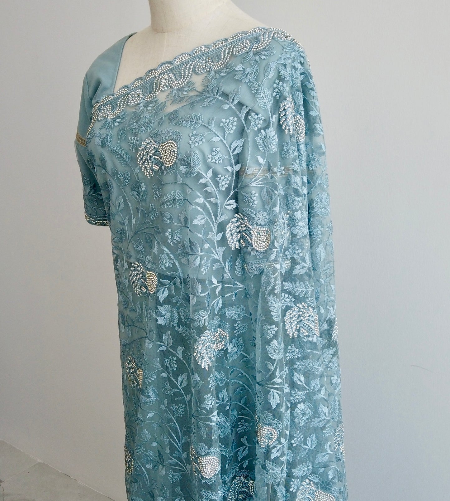 Handwoven embroidery and stone-adorned pallu - luxurious detailing adds depth and elegance to this refined blue ready to wear Saree