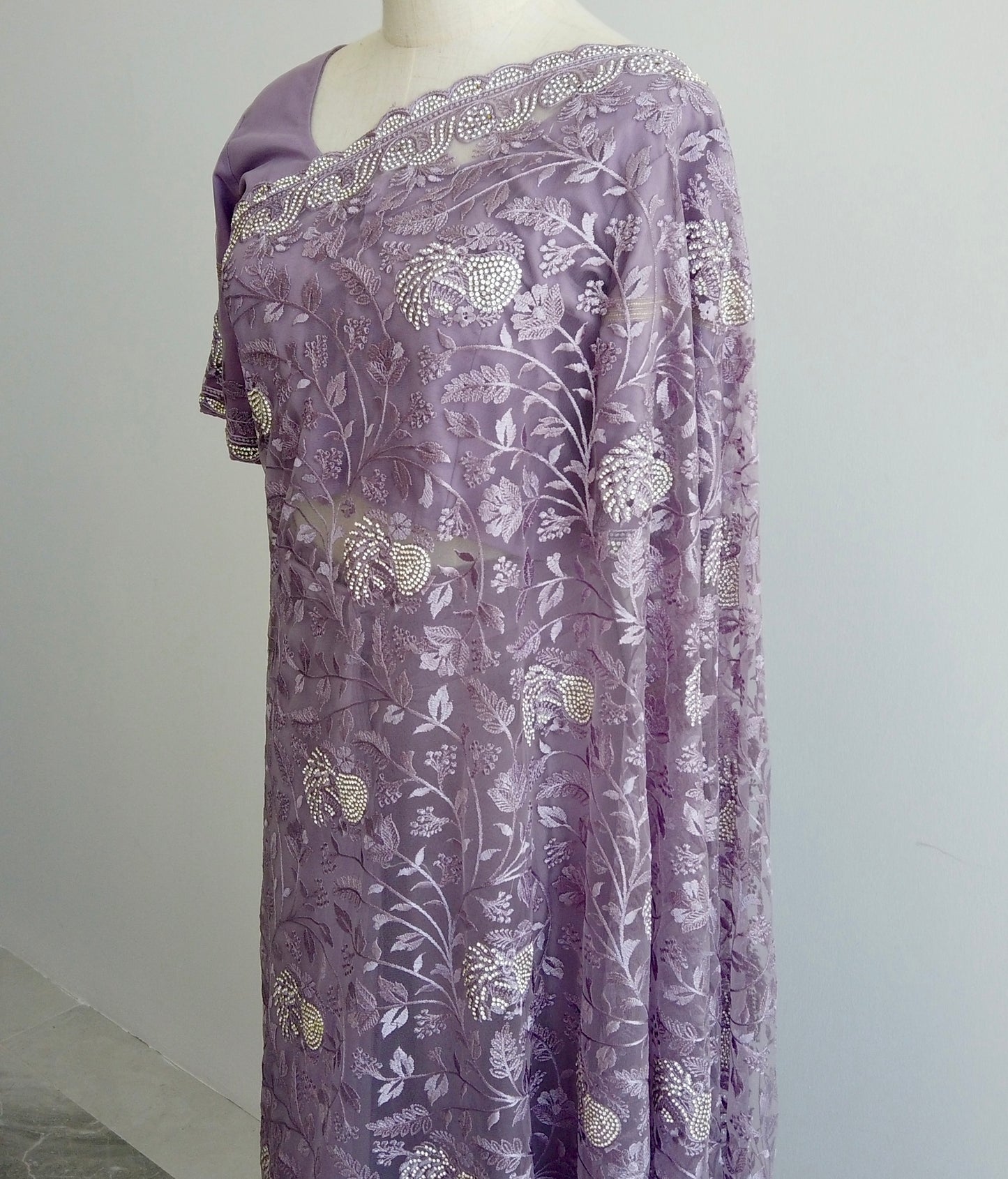 Close-up of ready to wear Saree, gold thread embroidery on sheer lavender net fabric