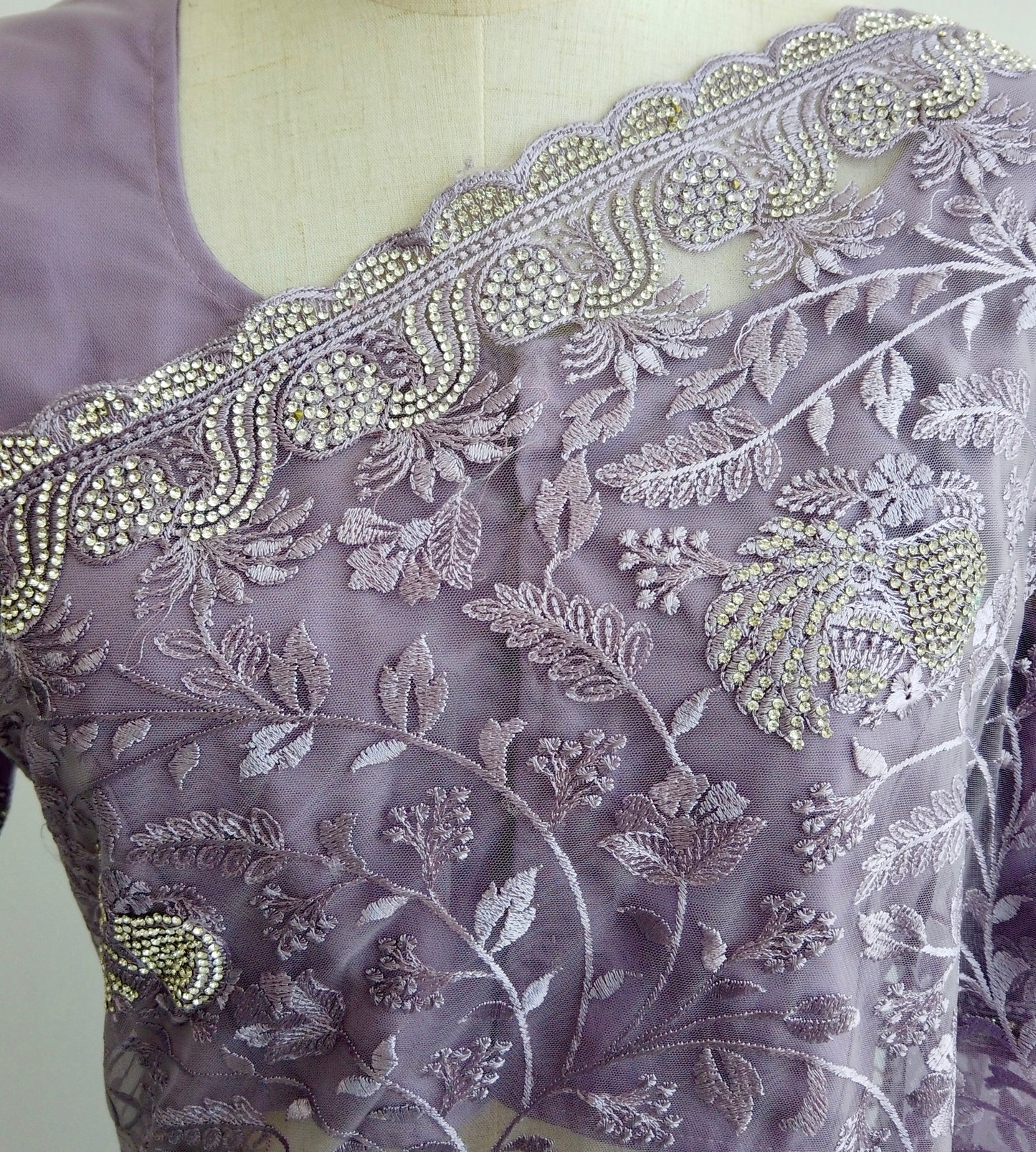 Flowing silhouette of purple embroidered saree with shimmering embellishments - premium soft net fabric enhances movement and elegance
