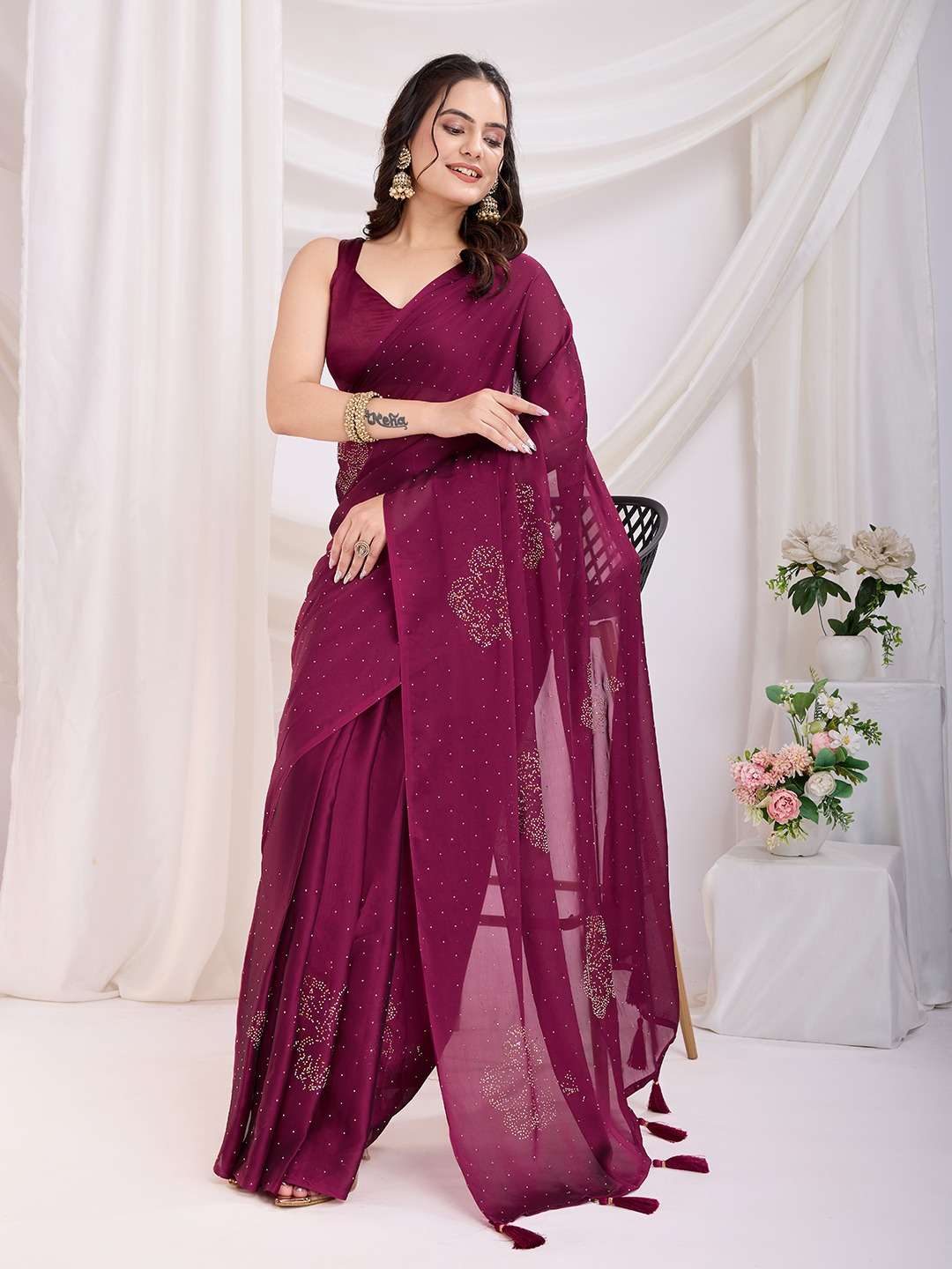 Maroon georgette saree with subtle sequin accents and regal fall.