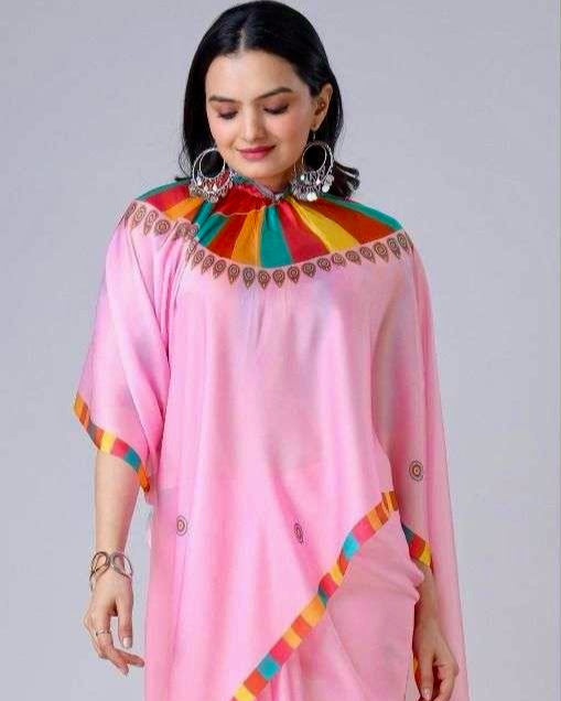 Woman wearing a pink saree with colorful patterns on a gray background