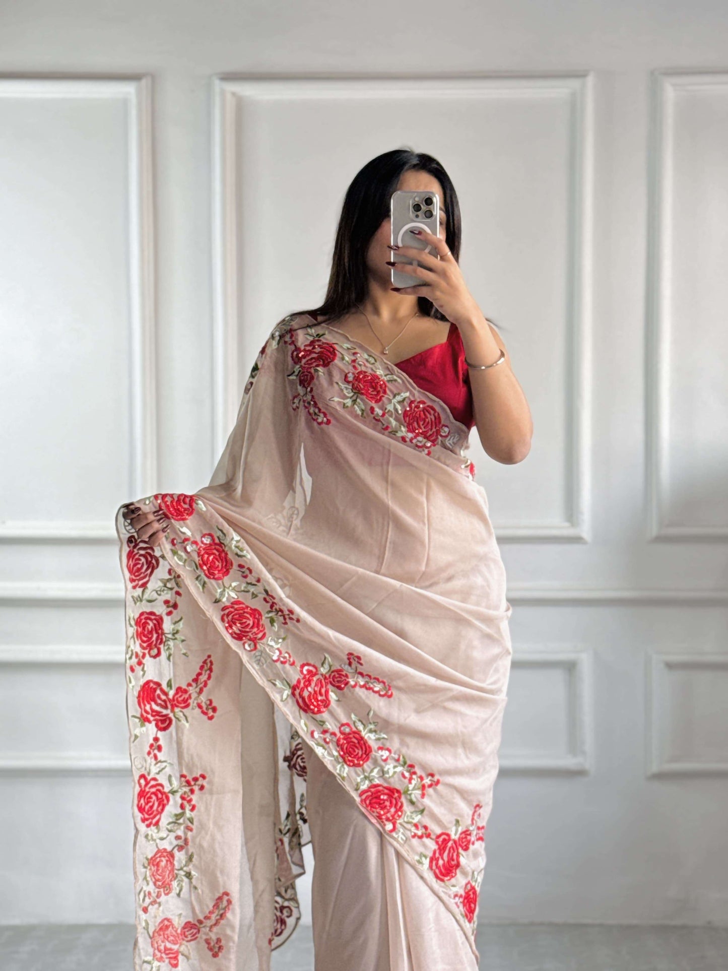Full-length view of beige organza saree showing pre-stitched pleats and elegant pallu.