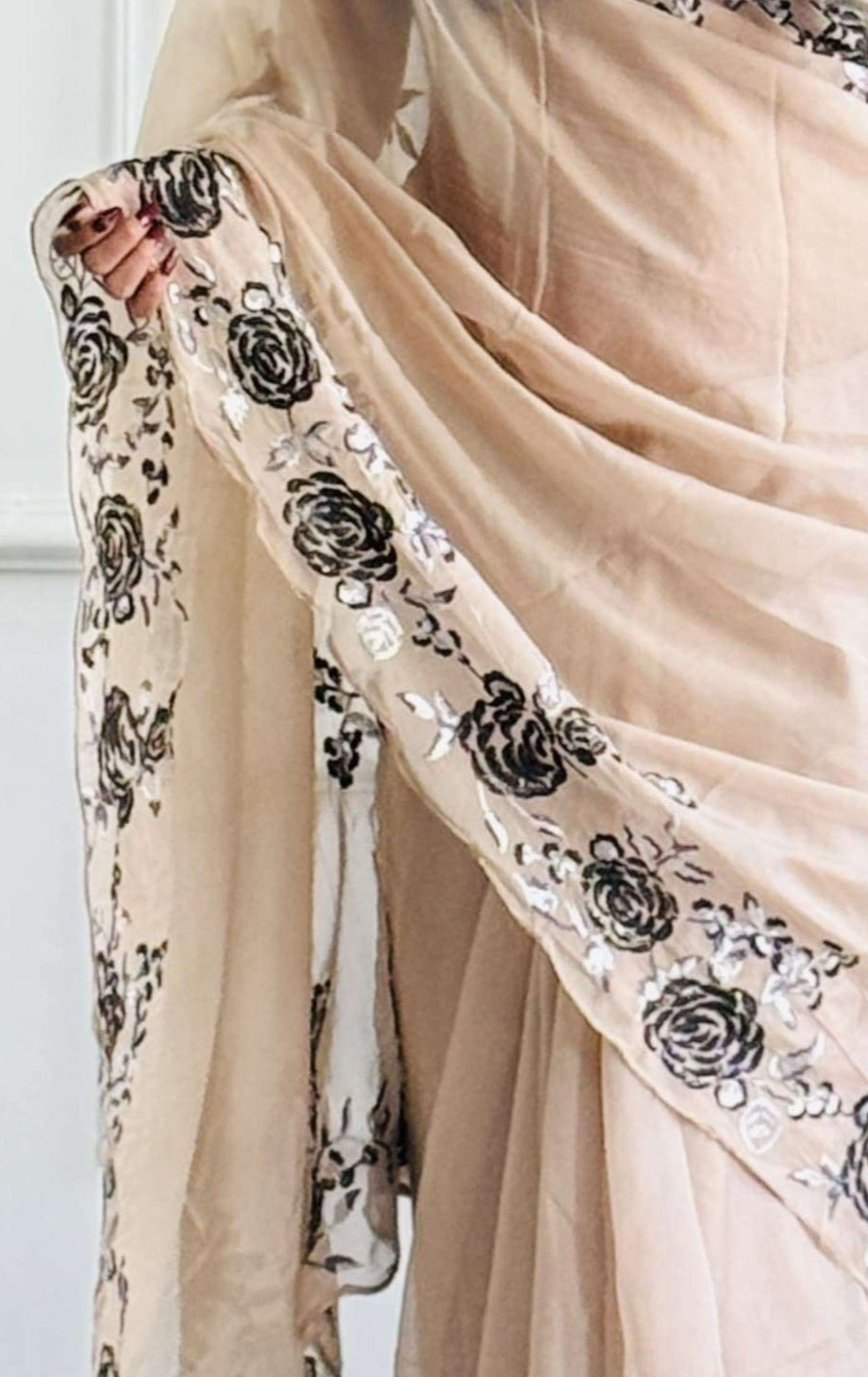 Black organza silk ready-to-wear saree with floral embroidery displayed on a mannequin