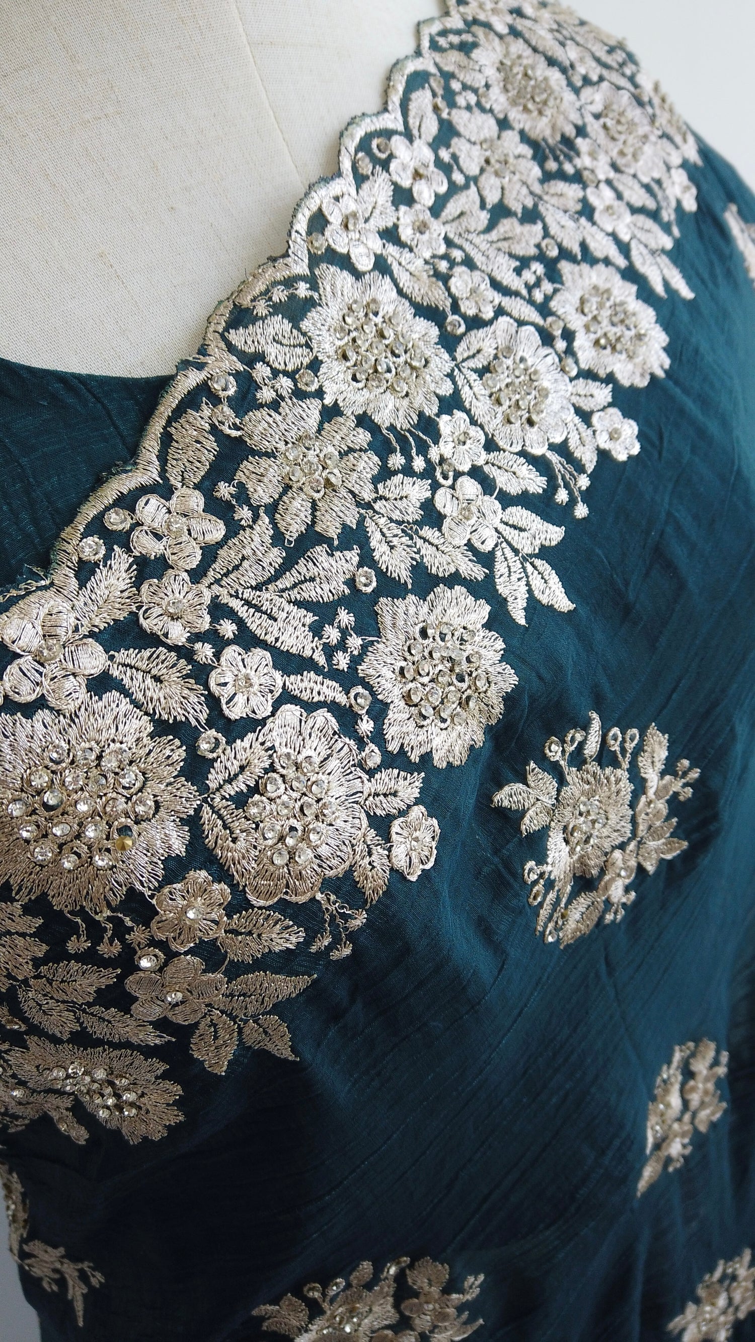 Rich green designer saree featuring delicate Zari patterns and hand-embellished stone detailing - perfect for formal and festive wear