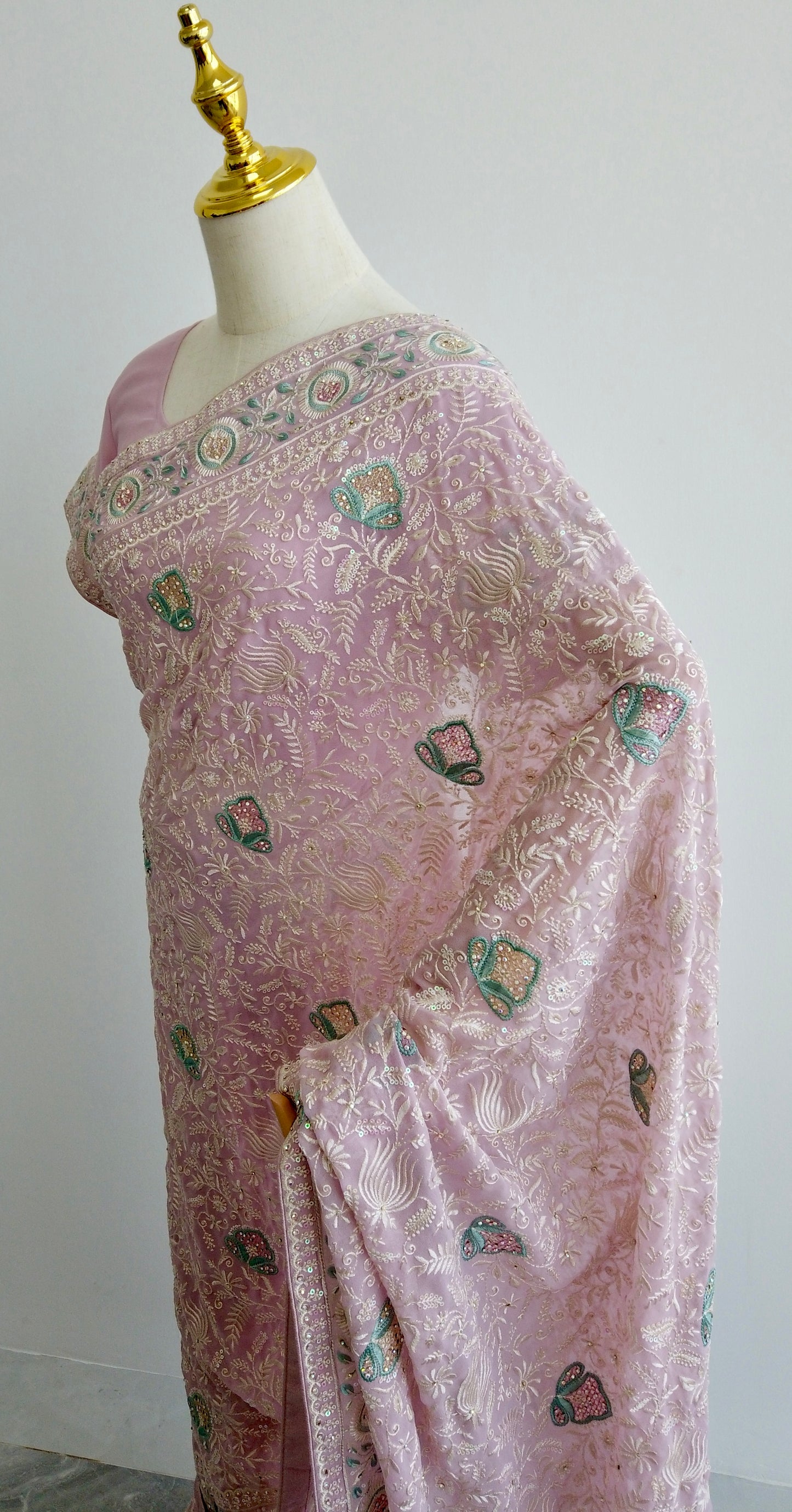 Full view of pastel pink Chikankari saree showing elegant pre-stitched pleats and pallu