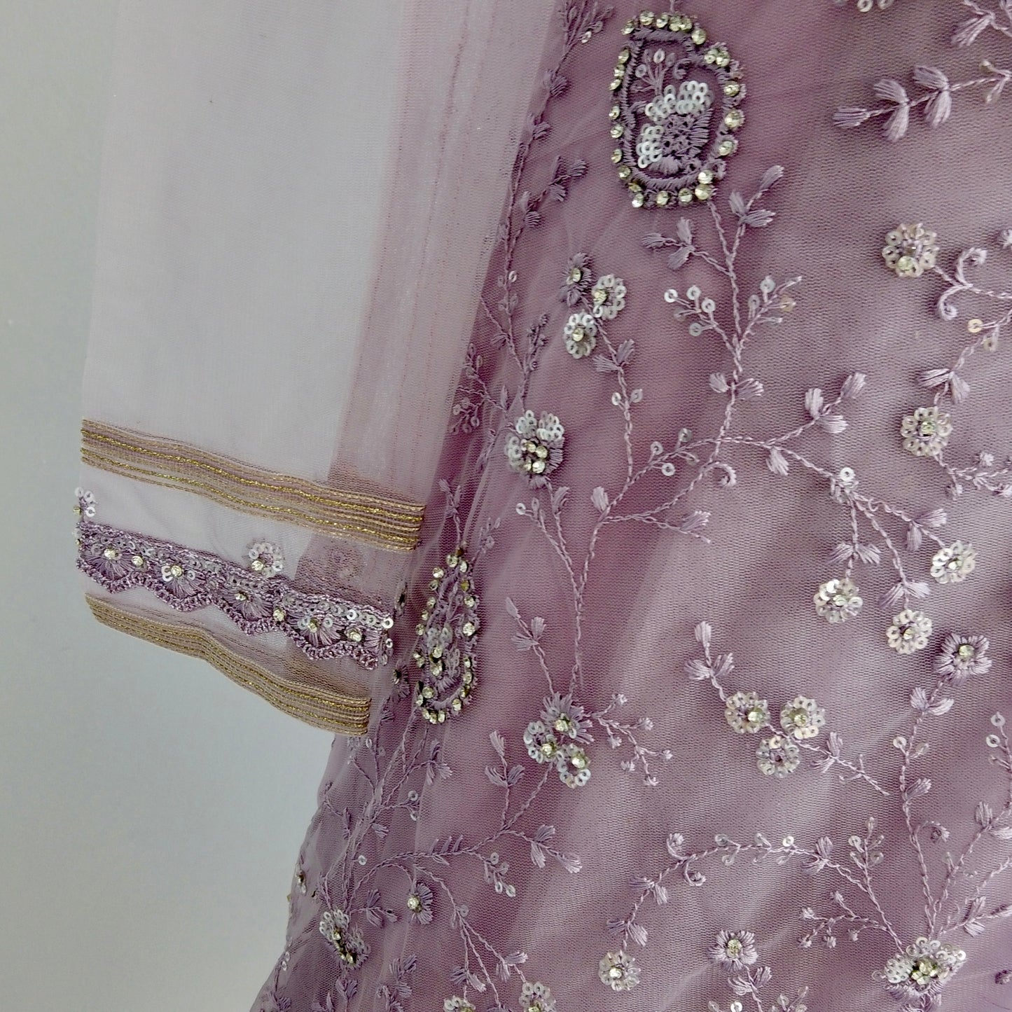 Hand-embroidered net saree with sequins and one sleeve blouse