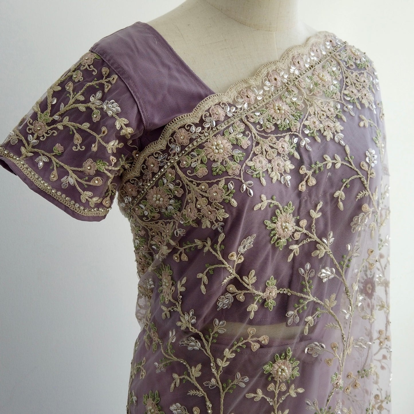 Purple embroidered net saree with intricate hand-stitched stone details - fusion of heritage and modern sophistication