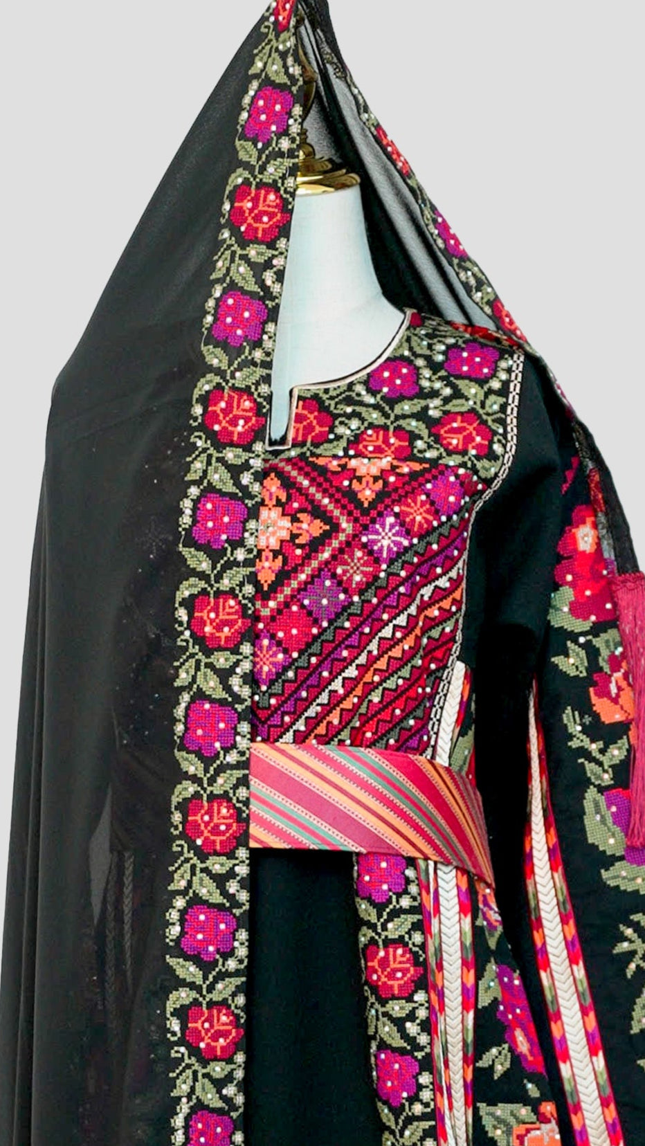 Close-up of intricate hand-stitched embroidery on chest and sleeves.