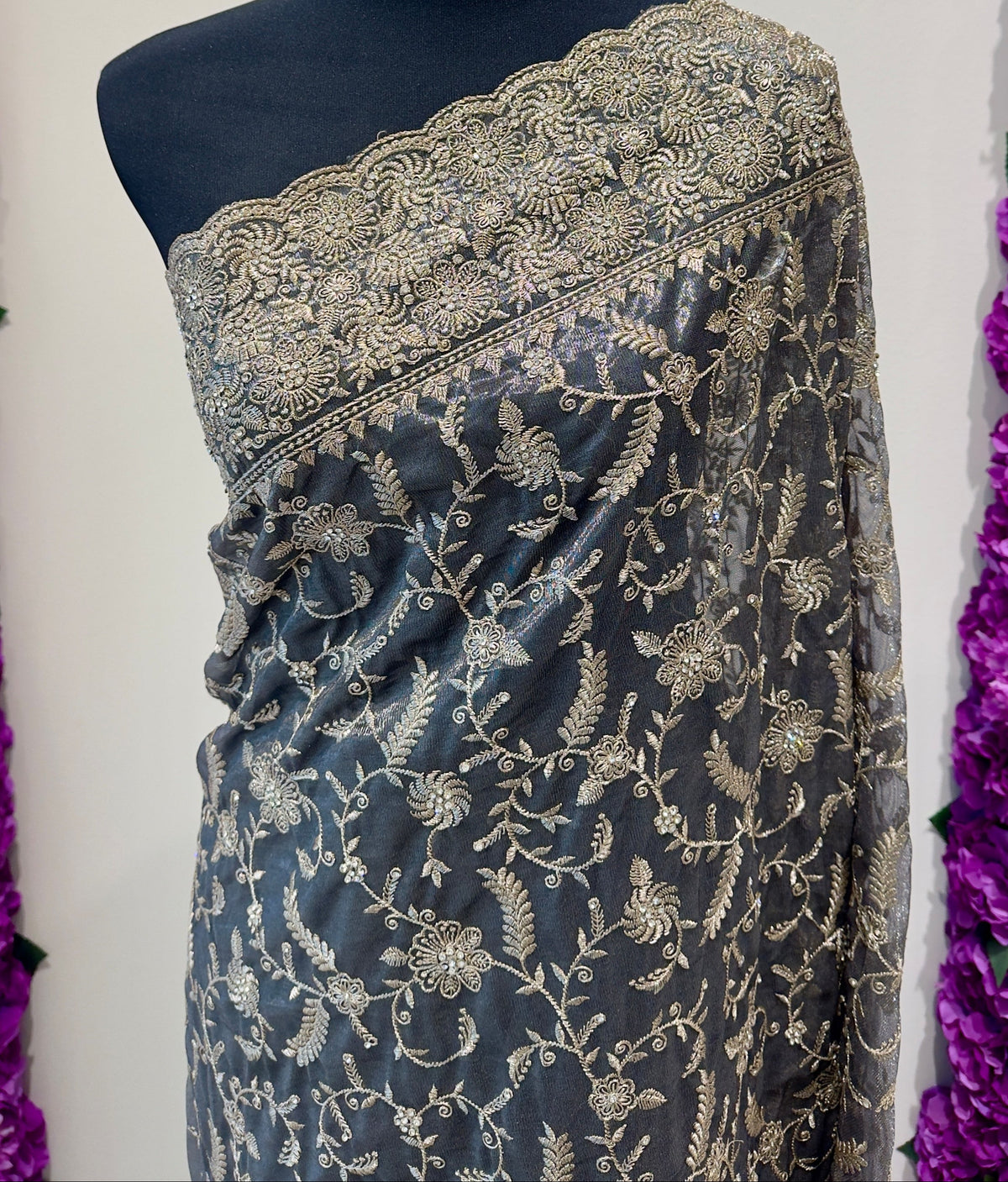 Saree - rich steel grey / smoky charcoal base with elegant gold embellishments, creating a timeless and sophisticated look.