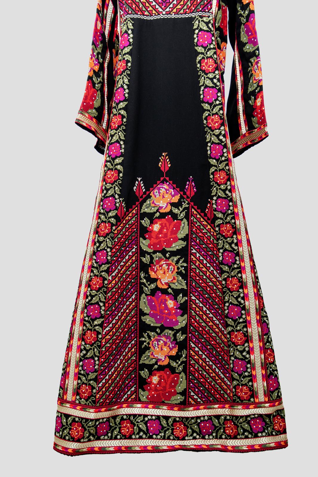 Front view of black Palestinian thobe with vibrant red, pink, and green floral embroidery