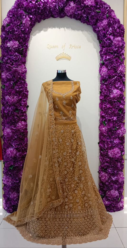 Party wear lehenga crafted from a premium silk-blend or satin silk fabric, richly adorned with intricate gold zari embroidery, sequins, and bead embellishments.