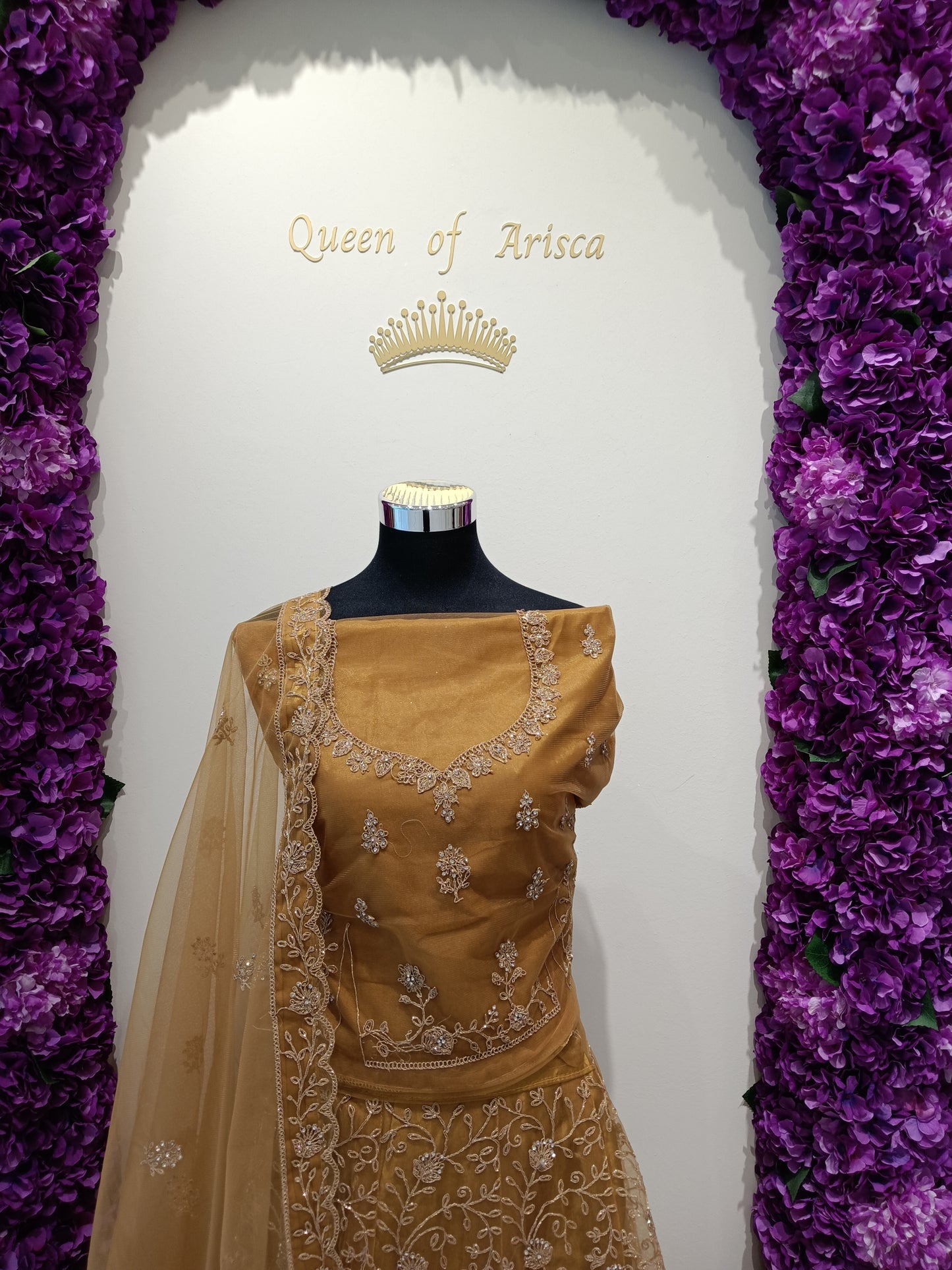 Sophisticated Antique Gold / Honey Gold lehenga beautifully complemented by shimmering gold embroidery and a matching gold net dupatta.