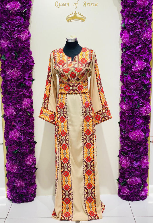 Champagne beige Palestinian-inspired thobe with red and orange geometric embroidery at Arisca Qatar.