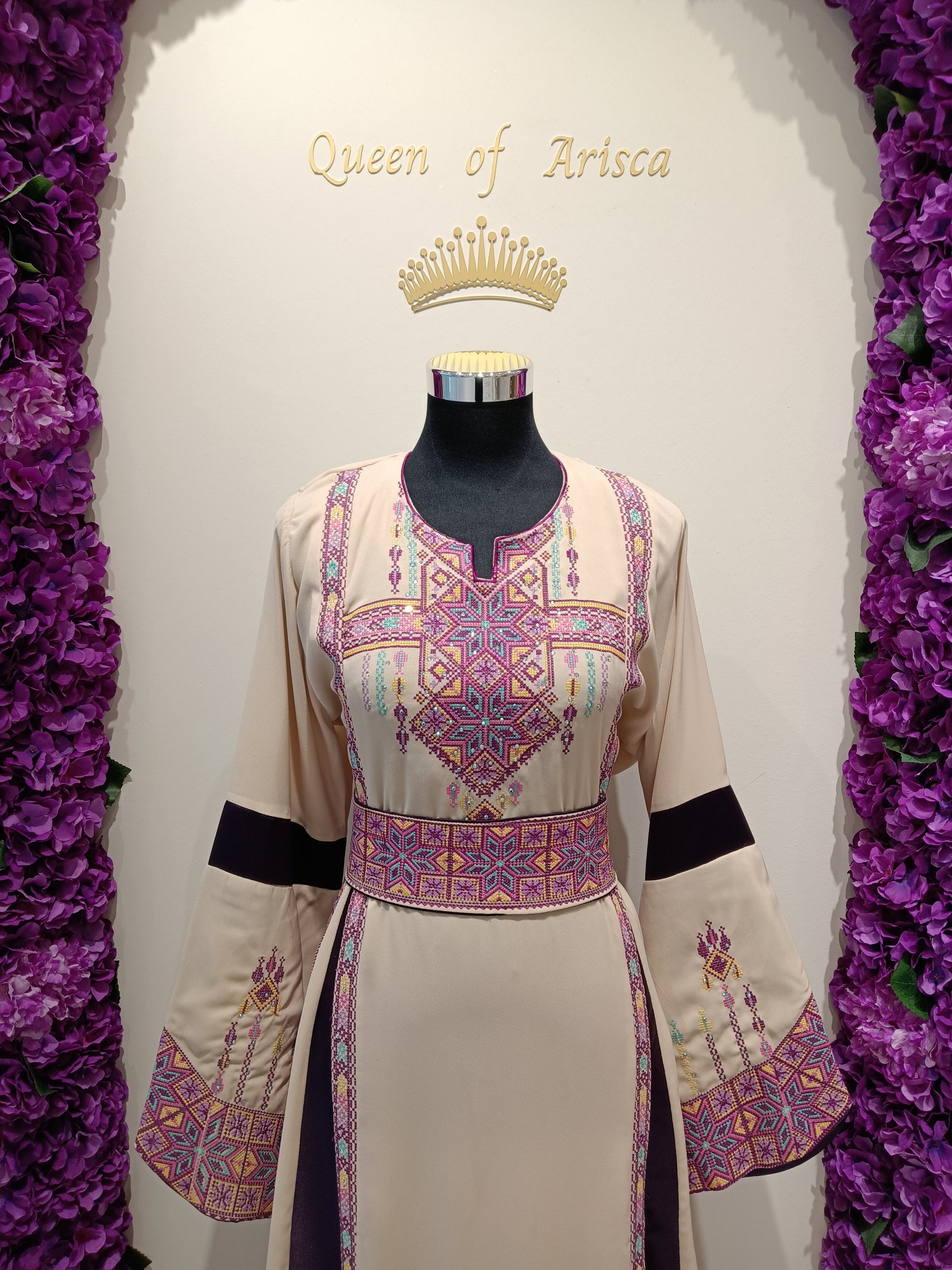 Elegant beige Palestinian thobe with traditional embroidery and plum accents.