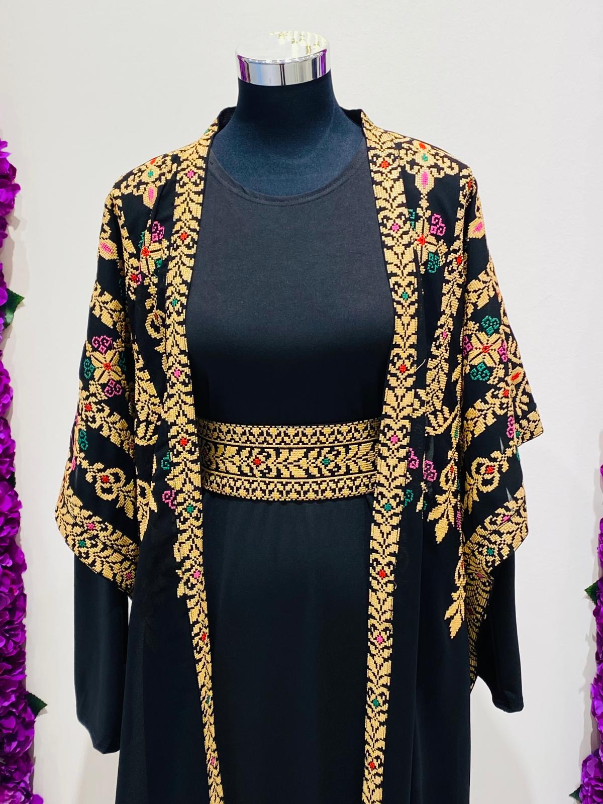 Luxury black Palestinian Thobe featuring royal gold Tatreez embroidery.