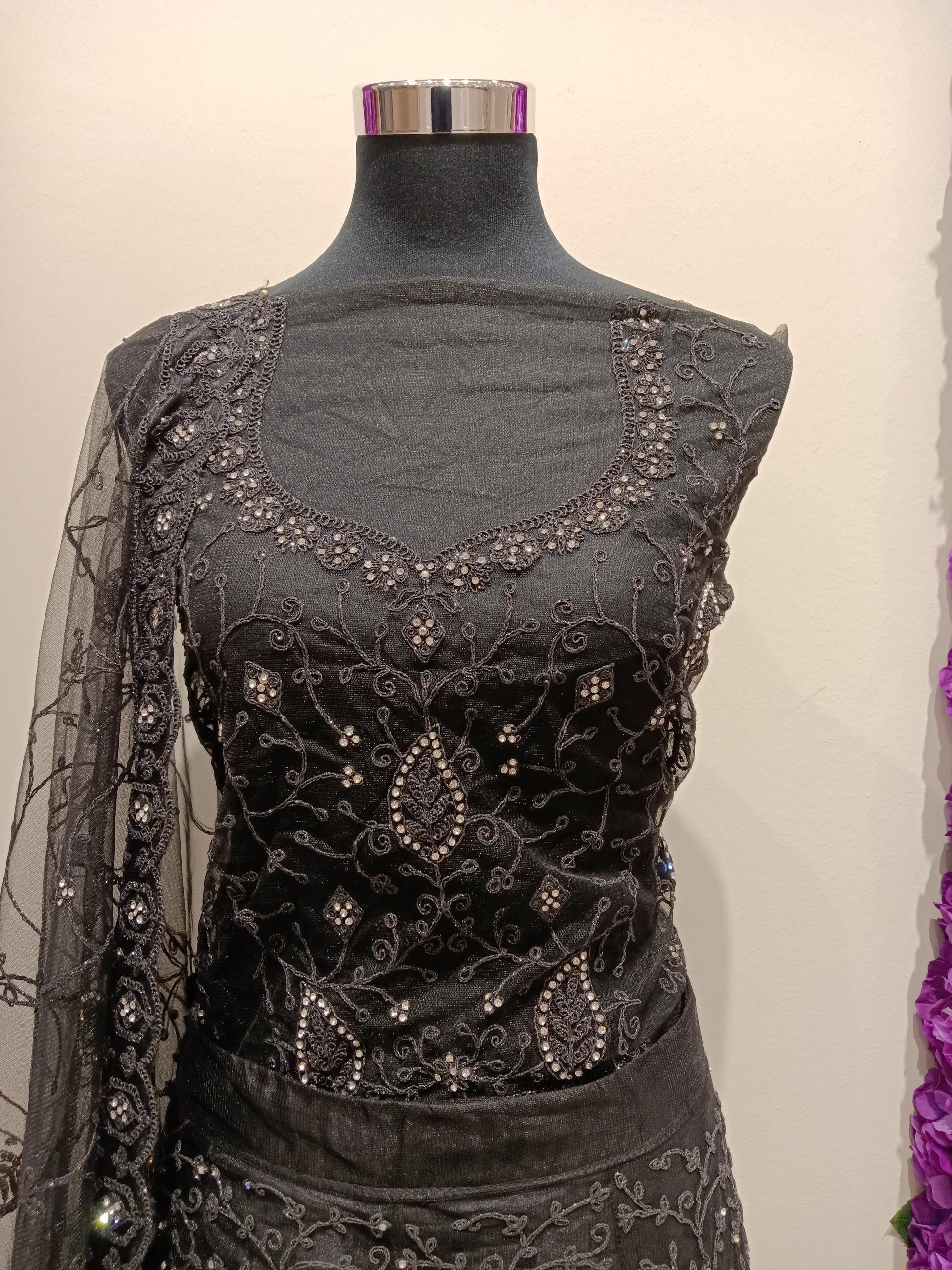 elegant black lehenga with silver and white stonework detailing.