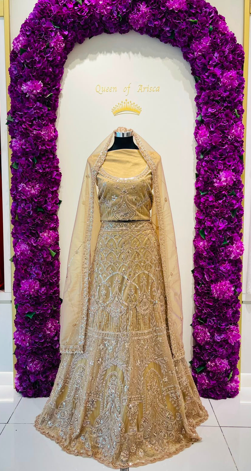 A beige and gold embroidered bridal lehenga