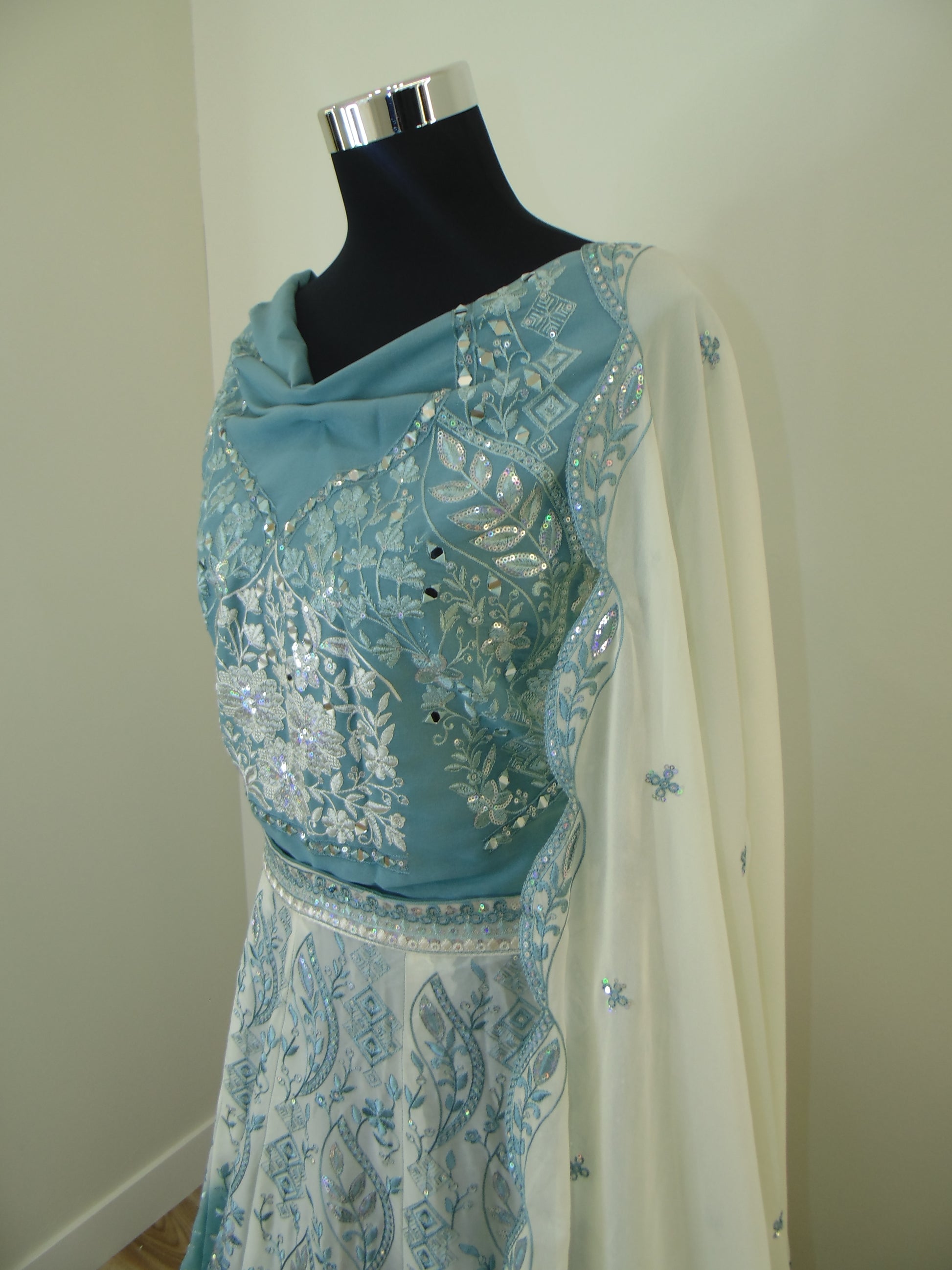 Light blue embroidered Lehenga on a mannequin against a white background