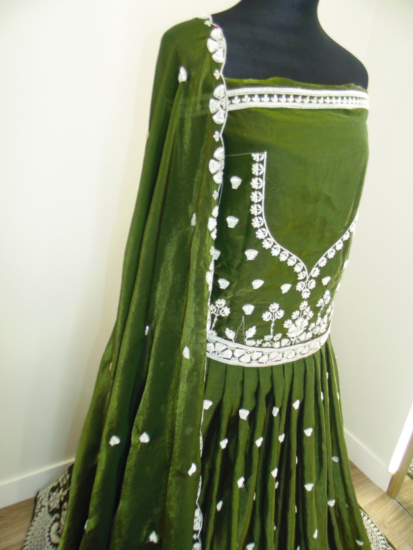 Green Lehenga with white embroidery on a white background