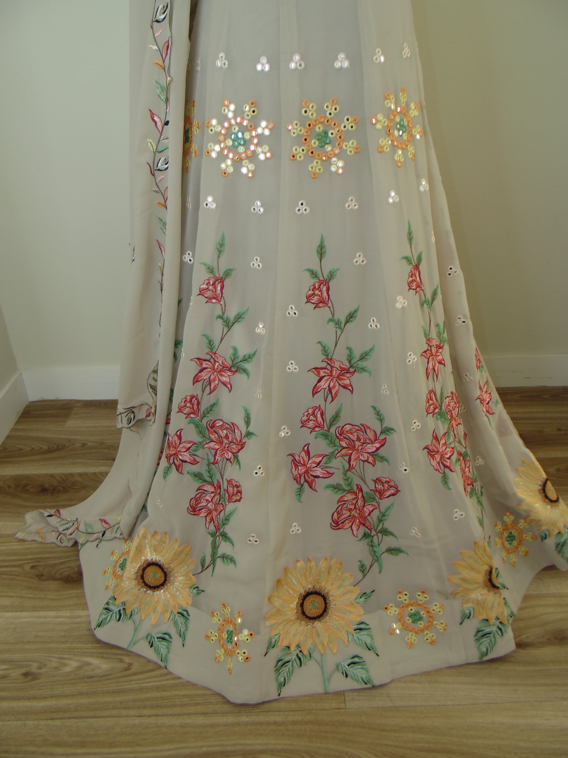 Embroidered fabric with floral patterns on a wooden surface