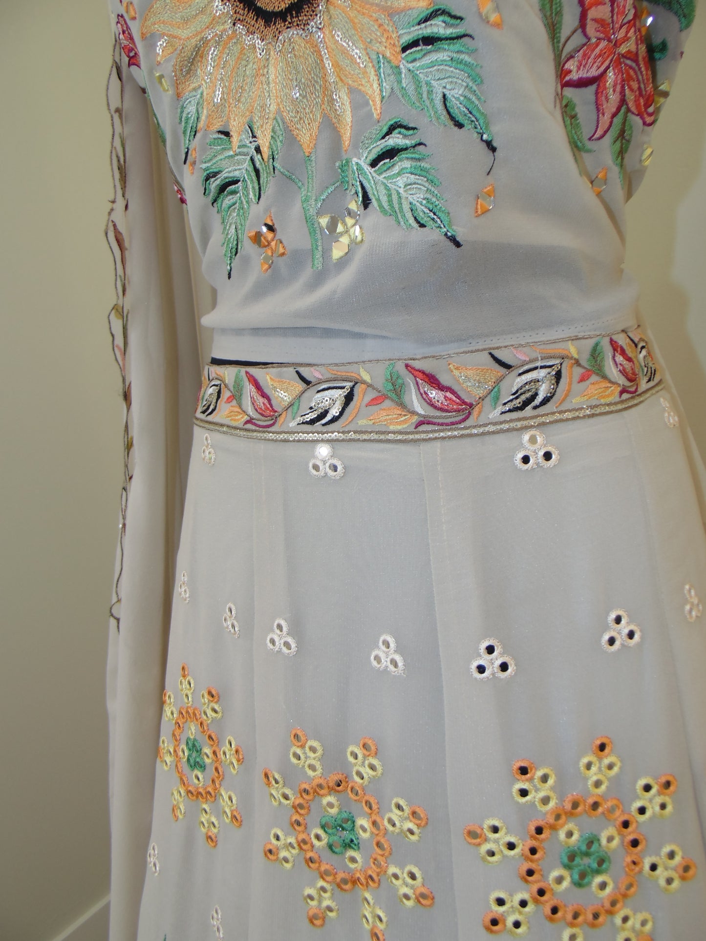 Embroidered fabric with colorful floral patterns on a plain background