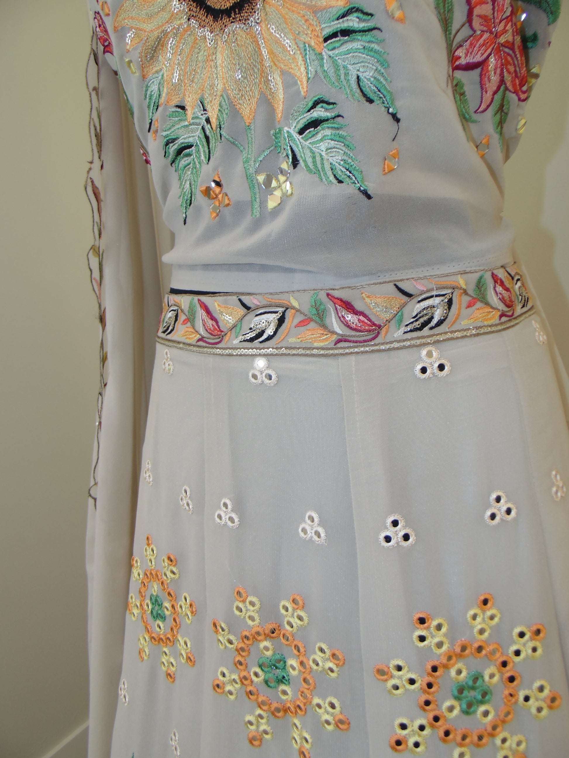 Embroidered fabric with colorful floral patterns on a plain background