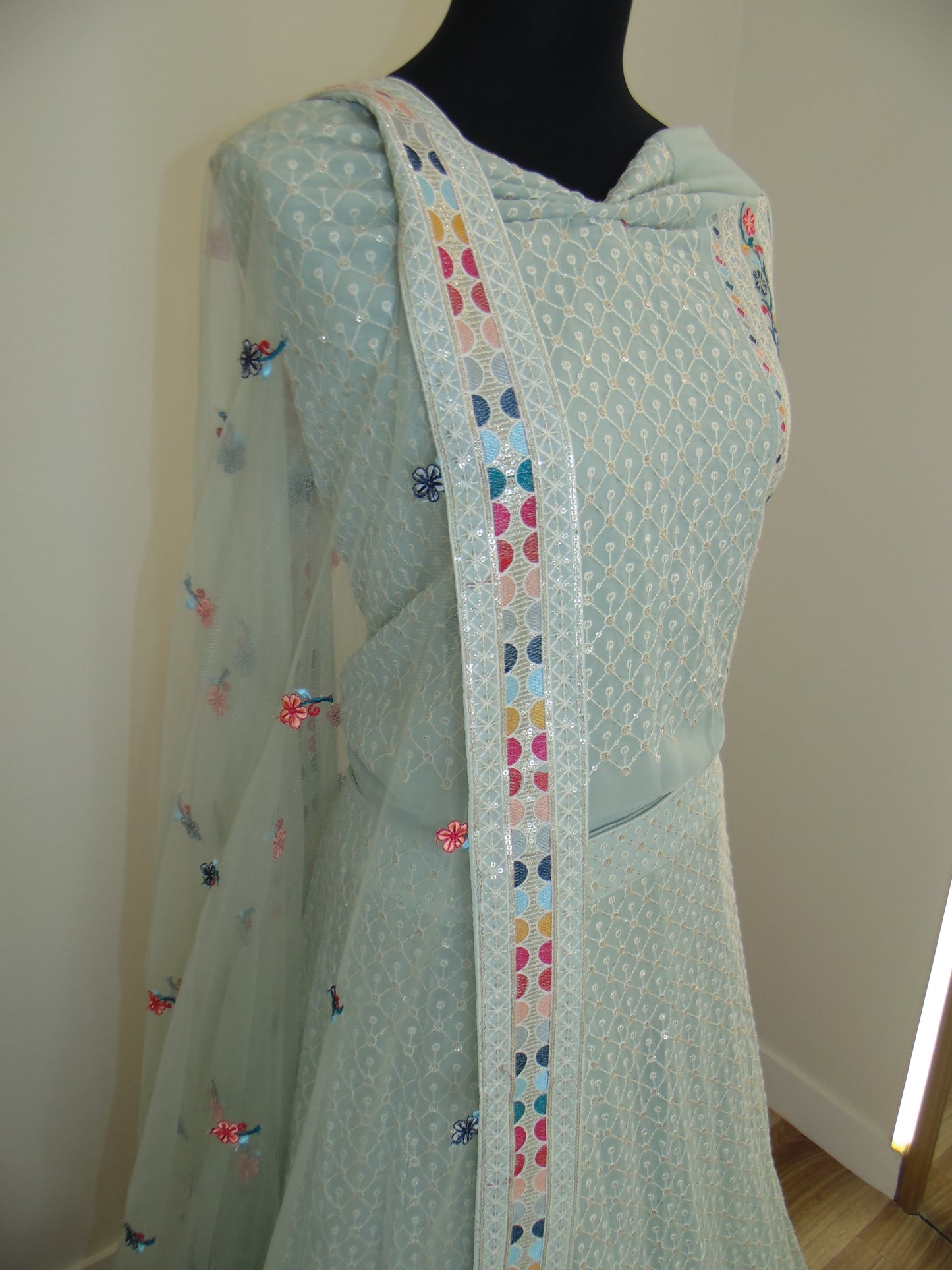 Light blue fabric with colorful heart patterns on a white background