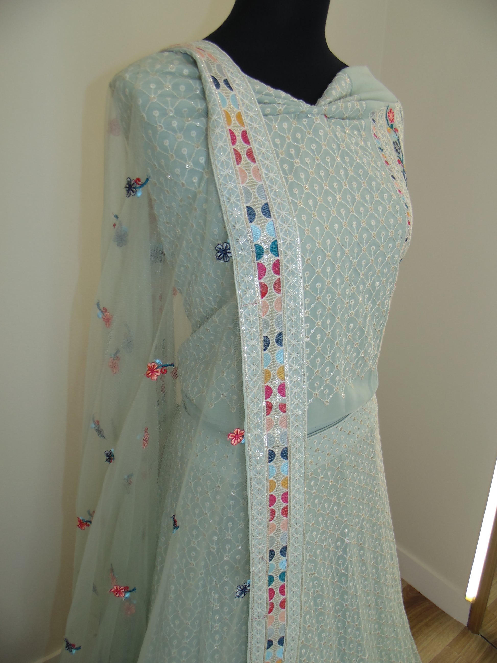 Light blue fabric with colorful heart patterns on a white background