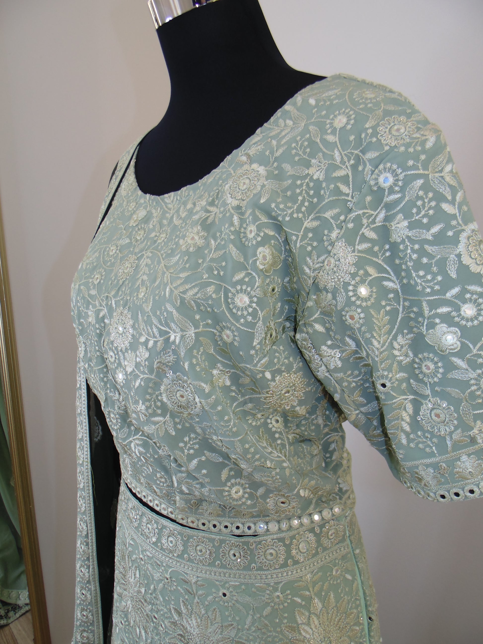 Light Green floral-patterned garment on a mannequin against a neutral background