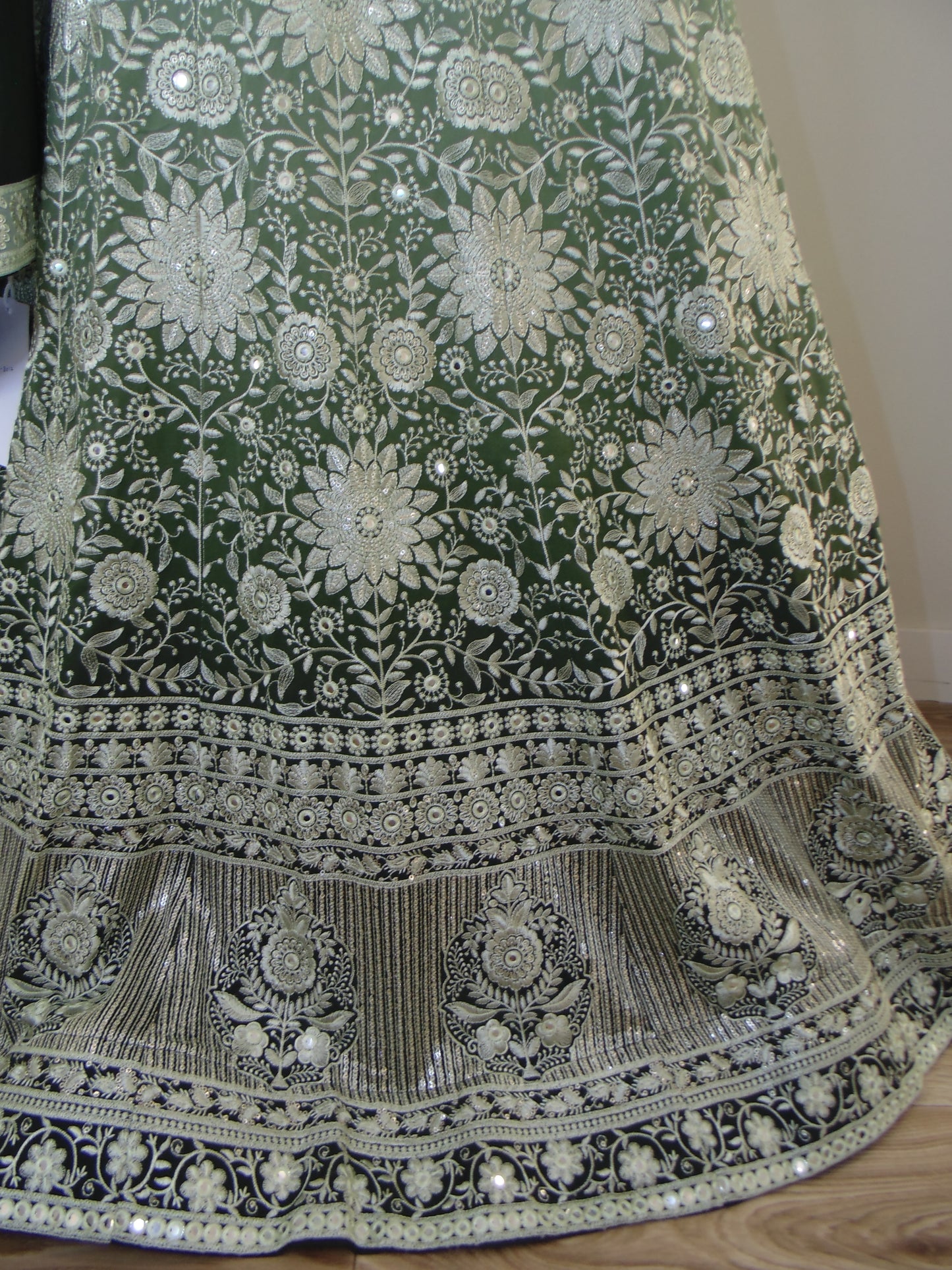 Decorative fabric with intricate patterns and embroidery on a plain background