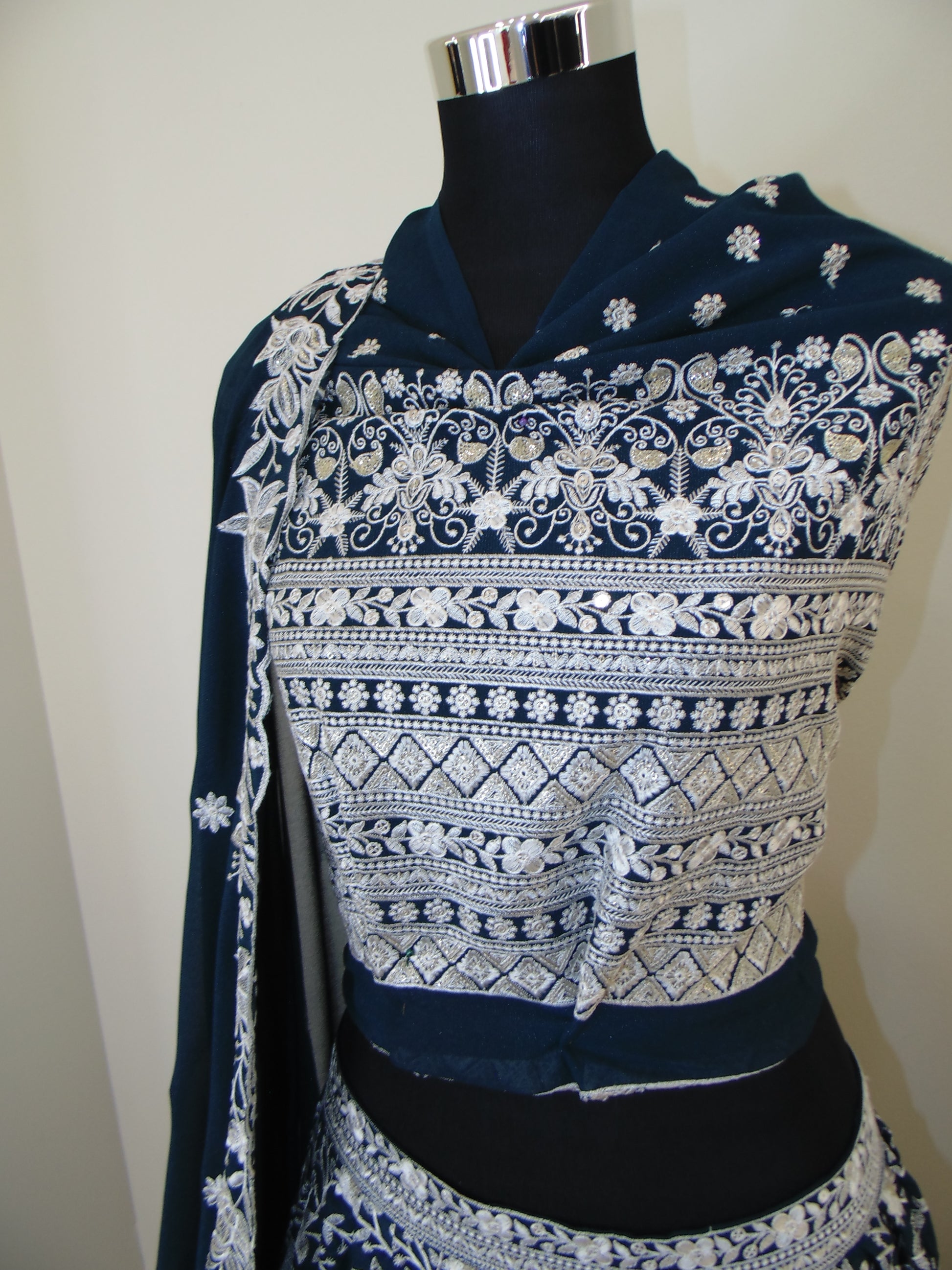 Blue Indian Lehenga with intricate white embroidery on a white background