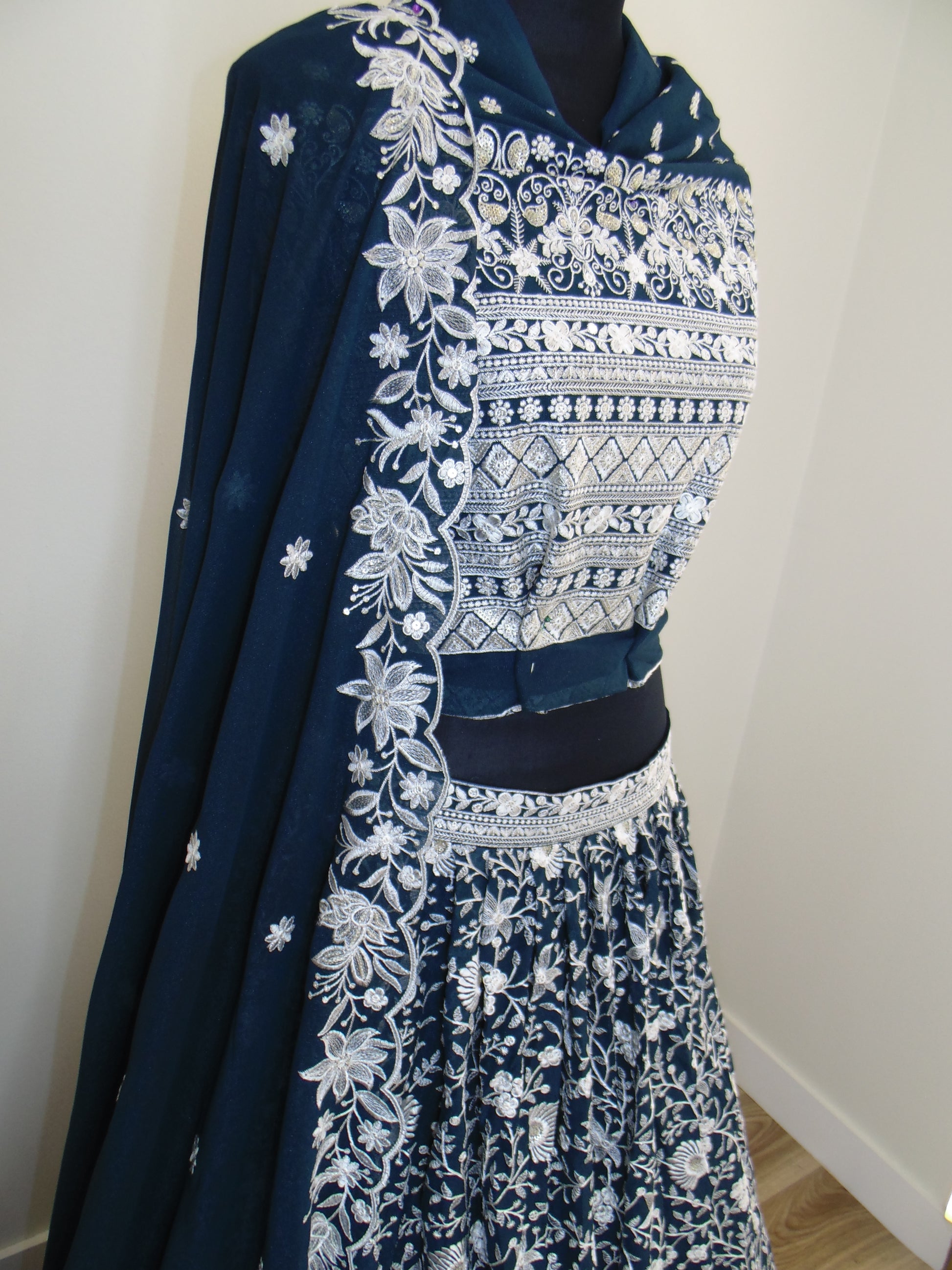 Navy blue fabric with white floral embroidery on a white background