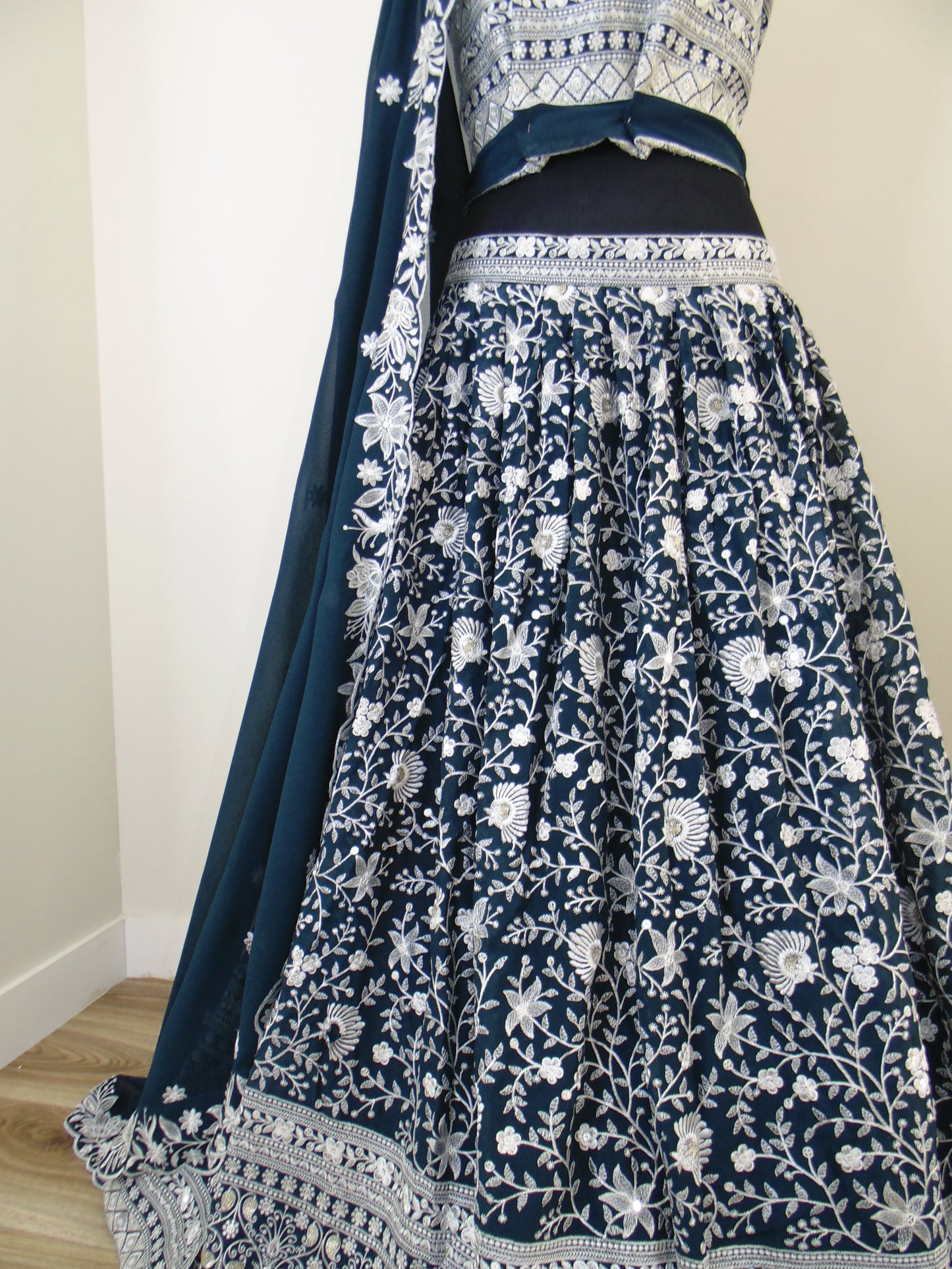 Blue and white floral patterned fabric on a wooden surface