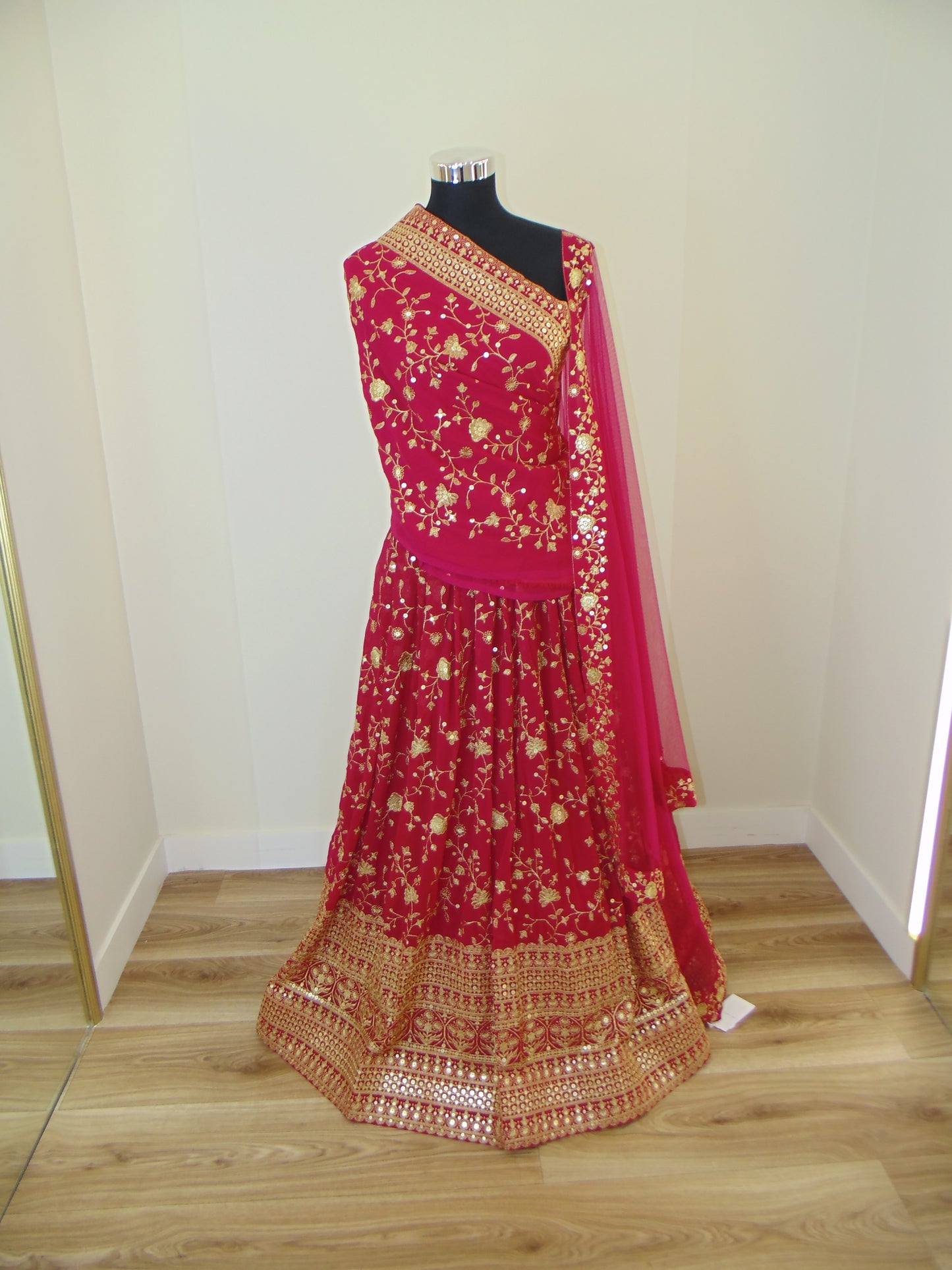 Red traditional outfit with gold embroidery on a white background