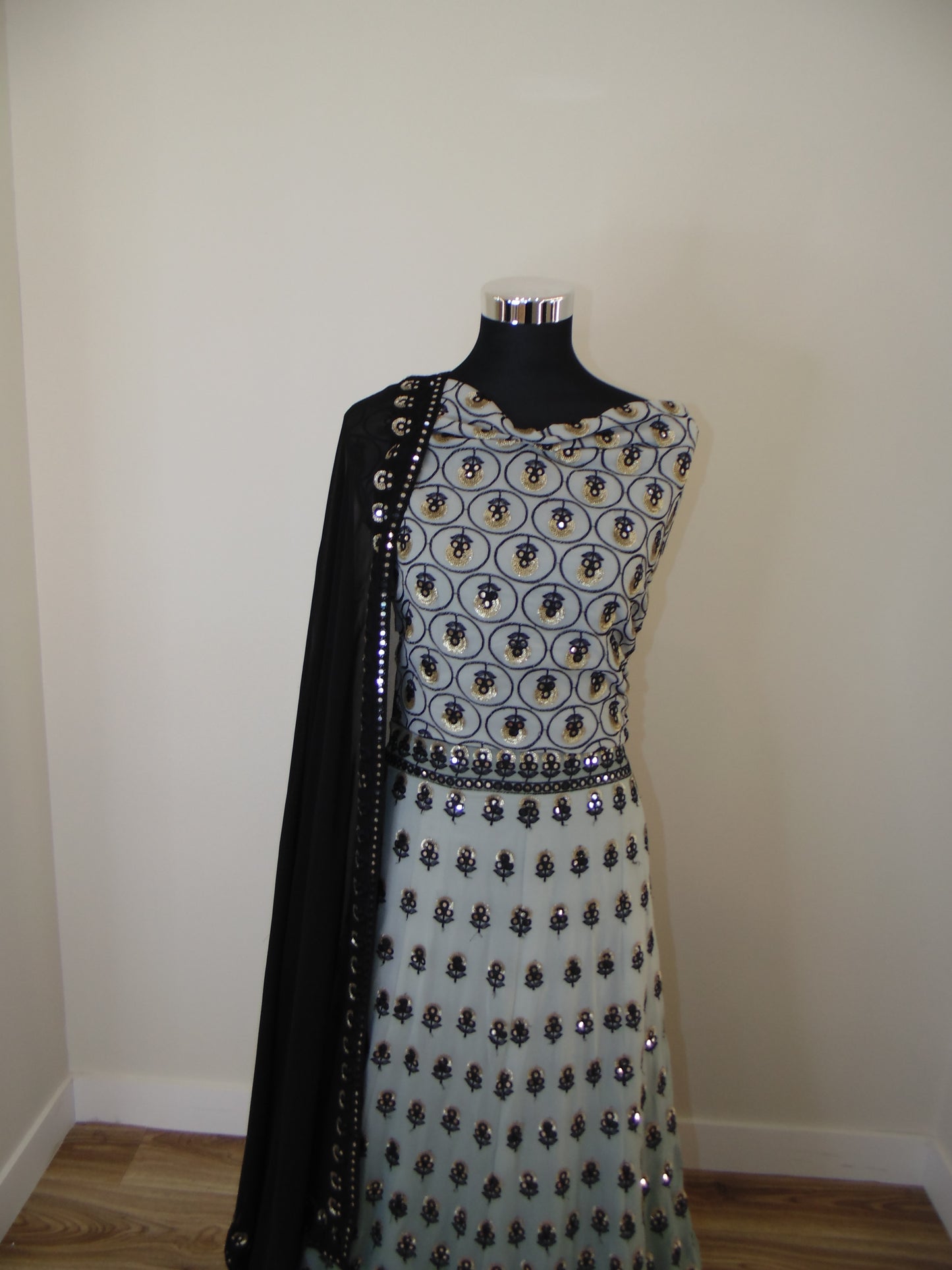 Black and white patterned dress on a mannequin against a plain background