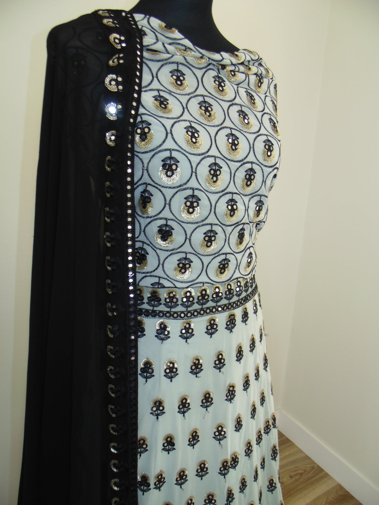 Patterned embroider lehenga with a zipper on a plain background