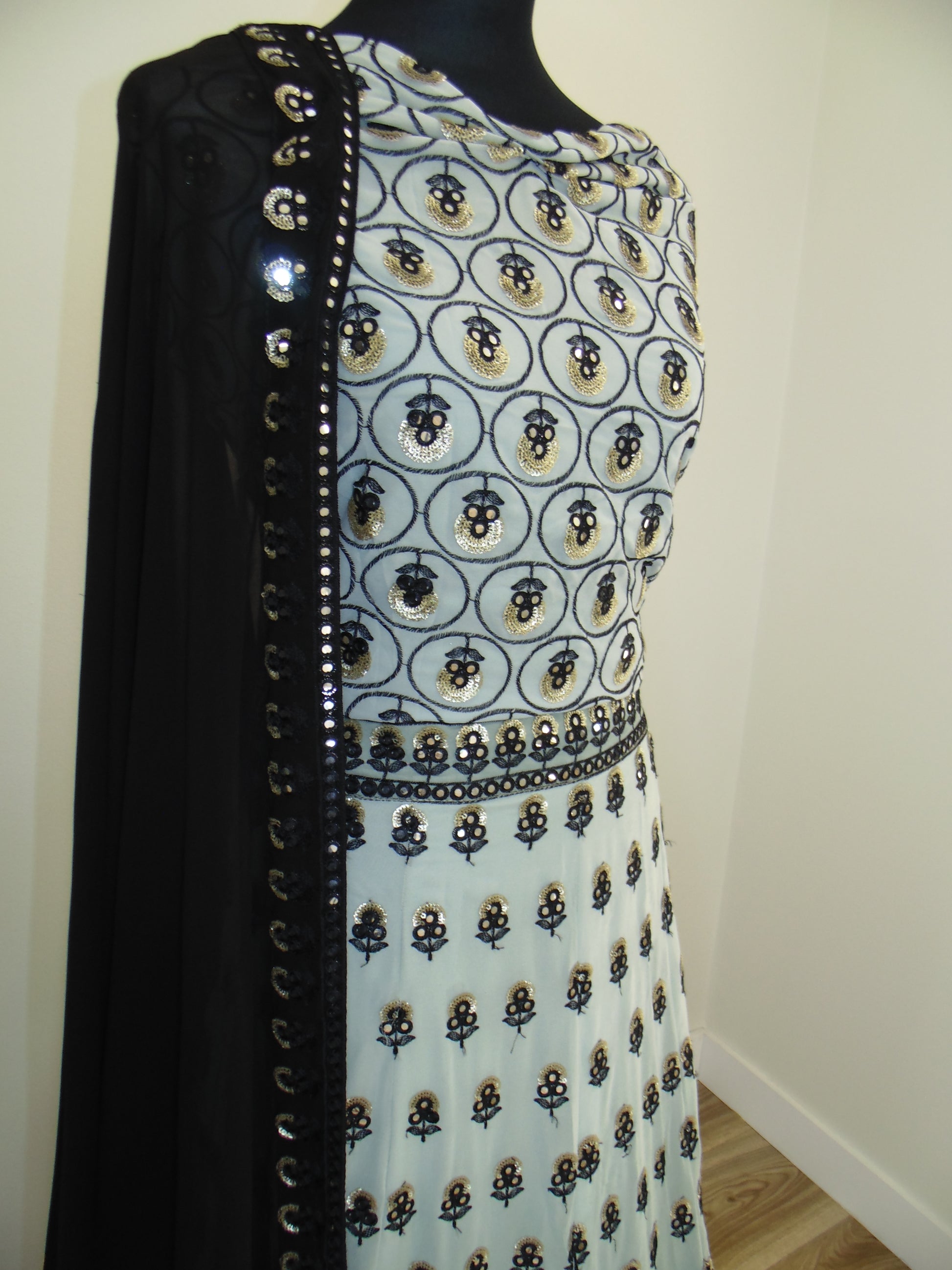 Patterned embroider lehenga with a zipper on a plain background