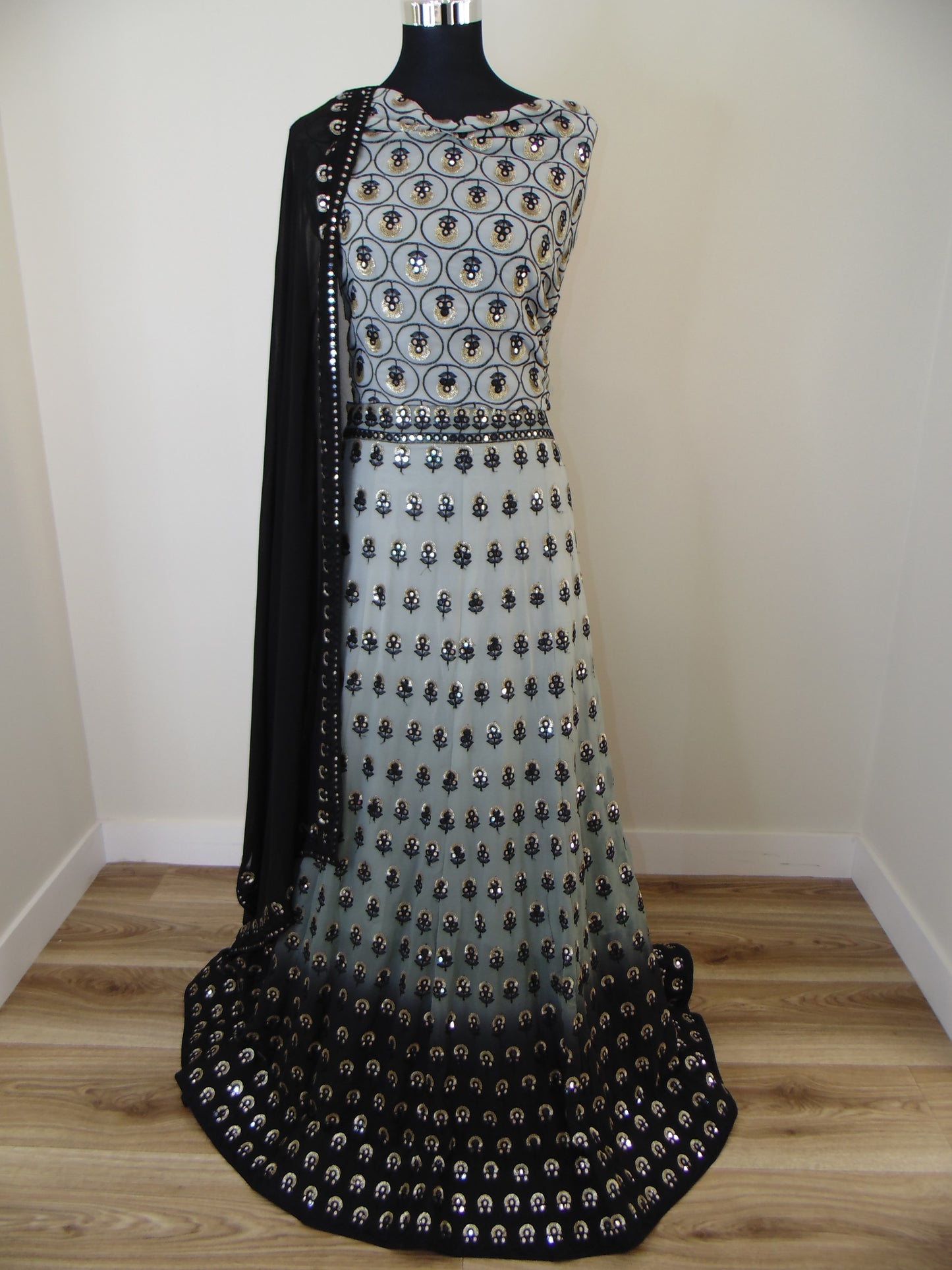 Black Indian lehenga with silver studs on a white surface