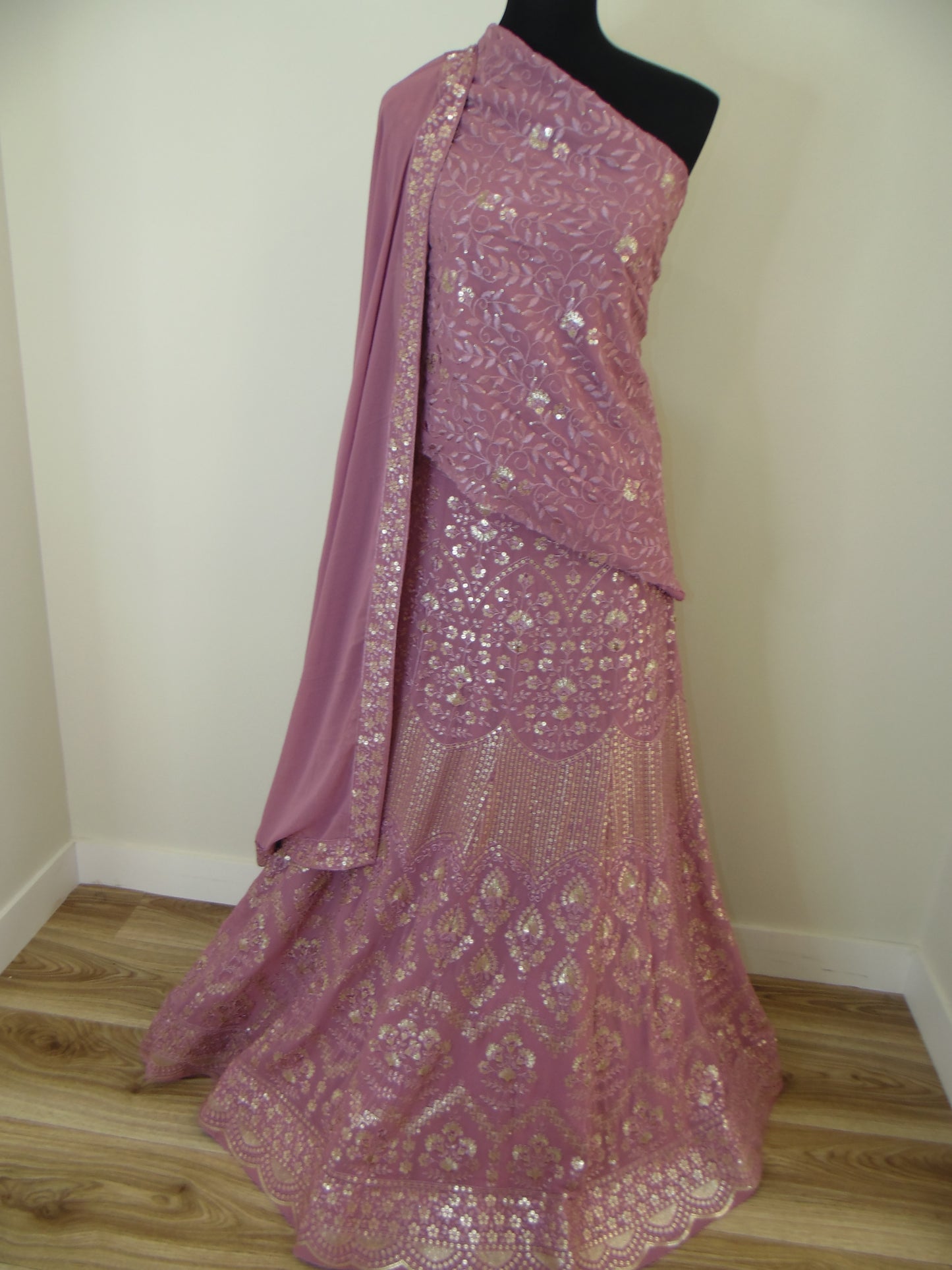 Pink lace fabric on a wooden surface