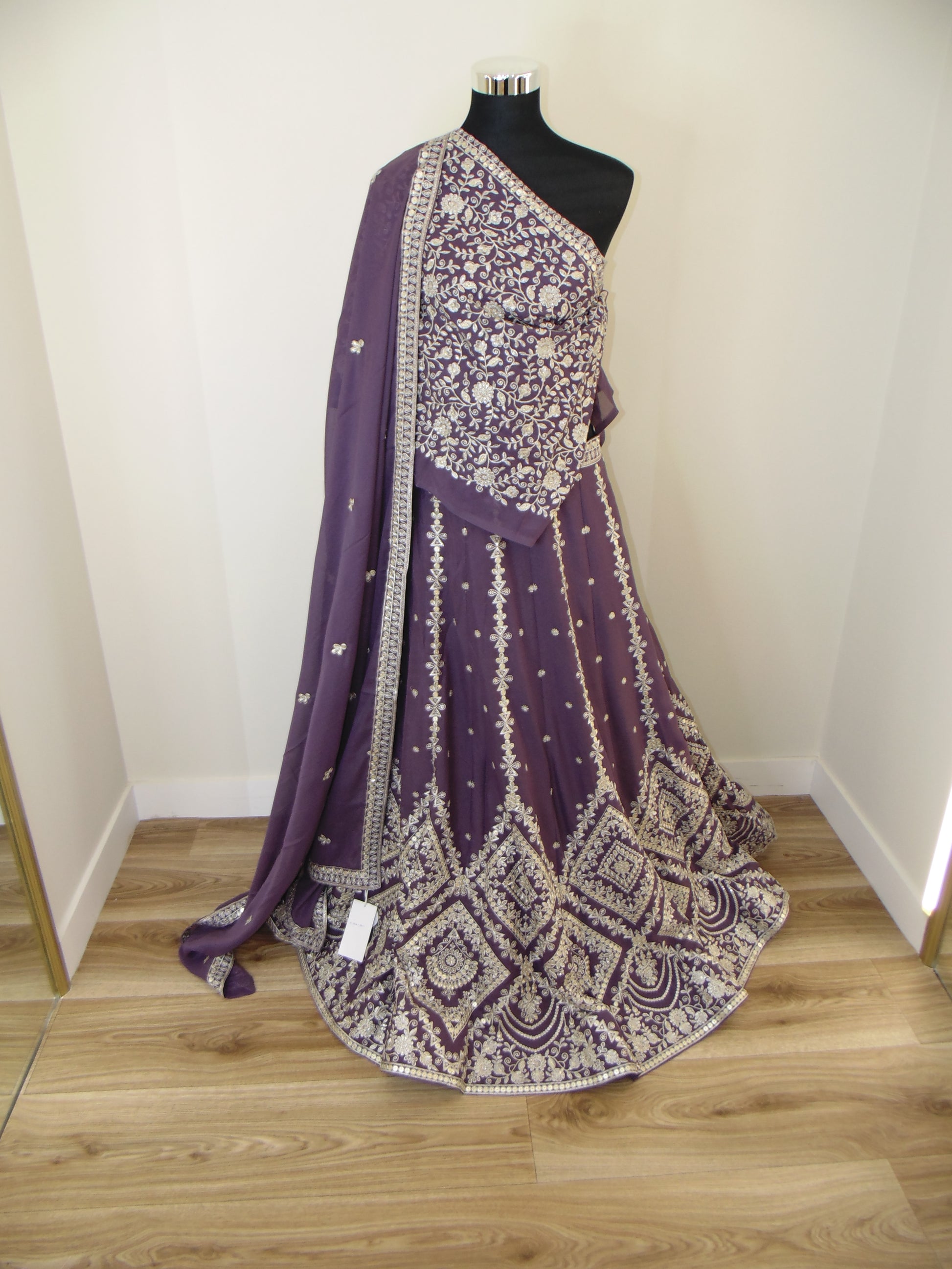Purple embroidered Lehenga draped over a Mannequin