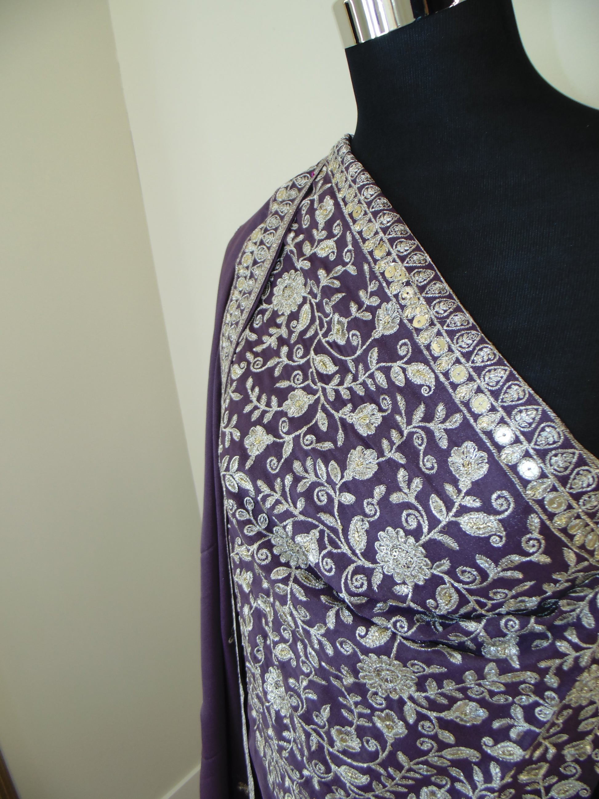 Purple fabric with floral patterns on a white surface